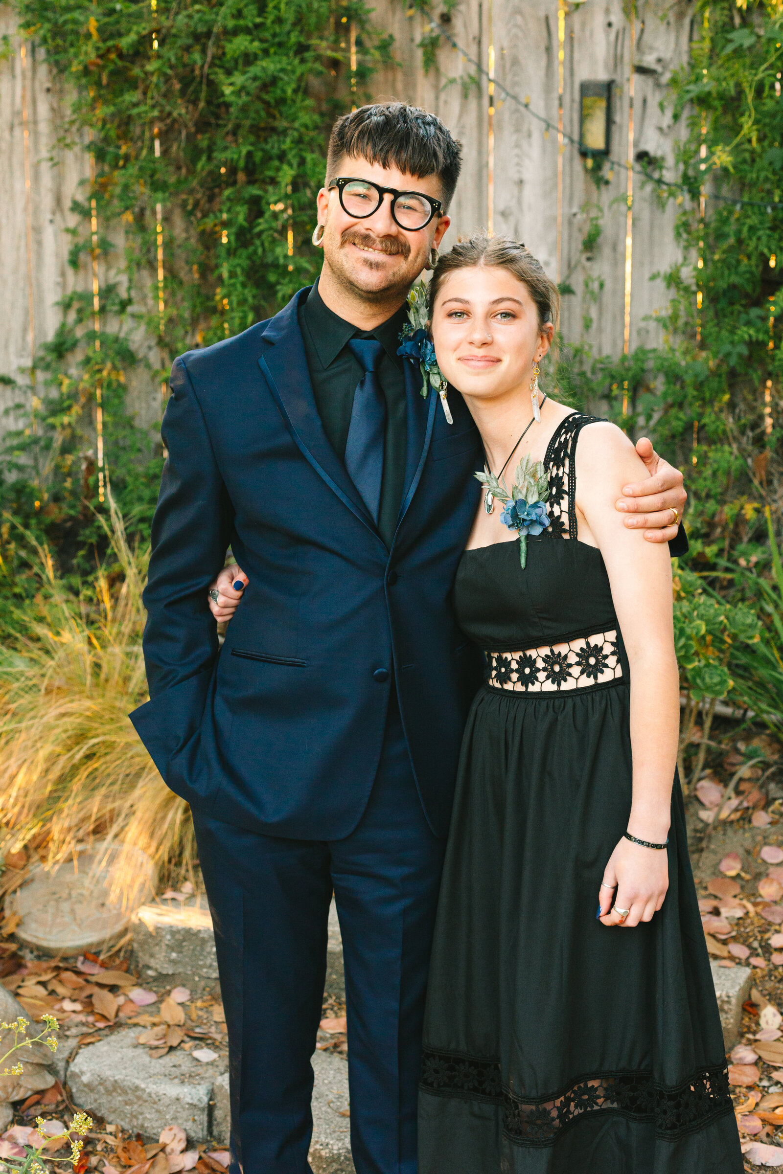 A groom with his goddaughter on his wedding day.