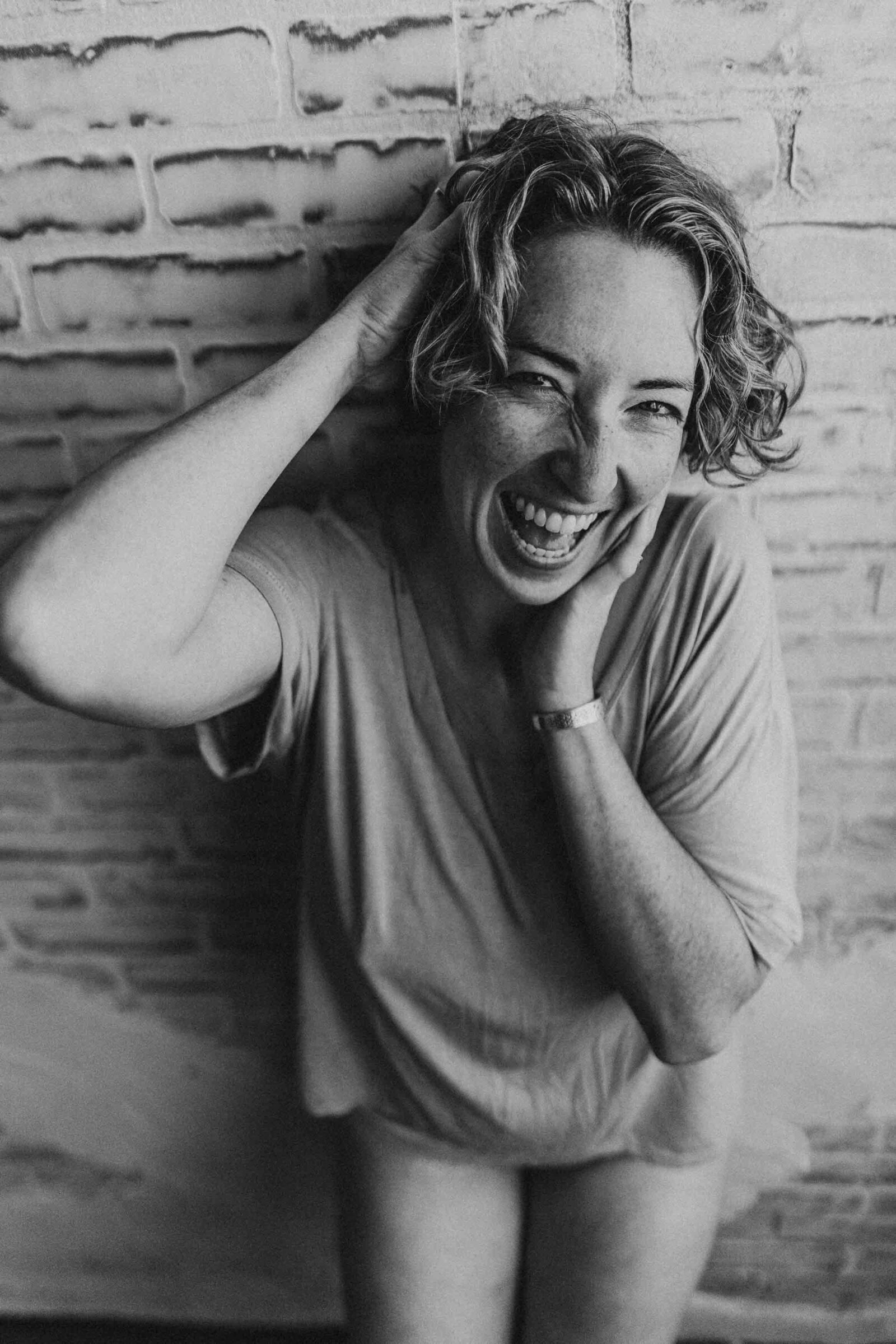 black and white photo of a laughing woman