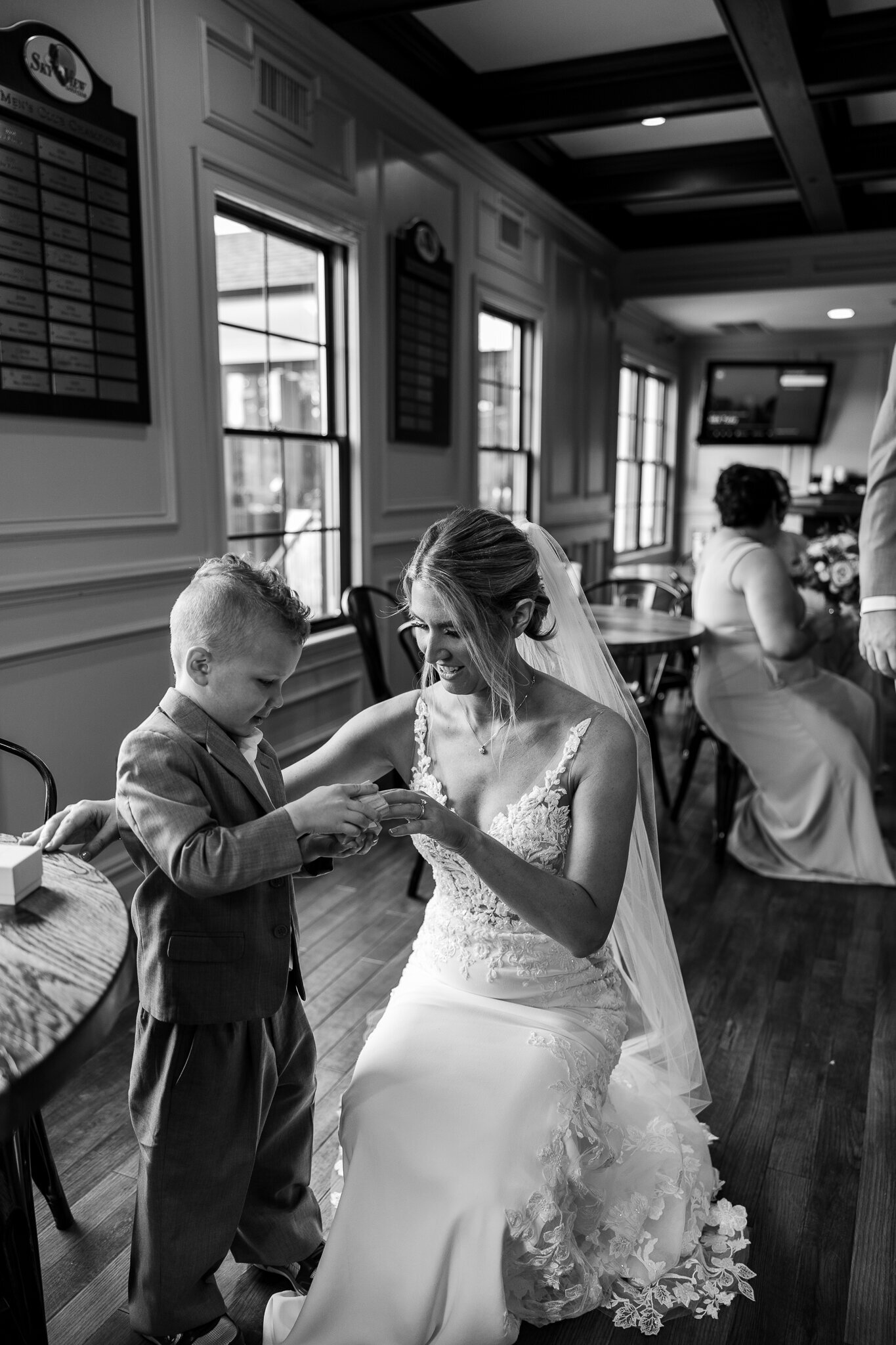 Bride smiling with her young nephew, the ring bearer, before ceremony at SkyView Golf Club
