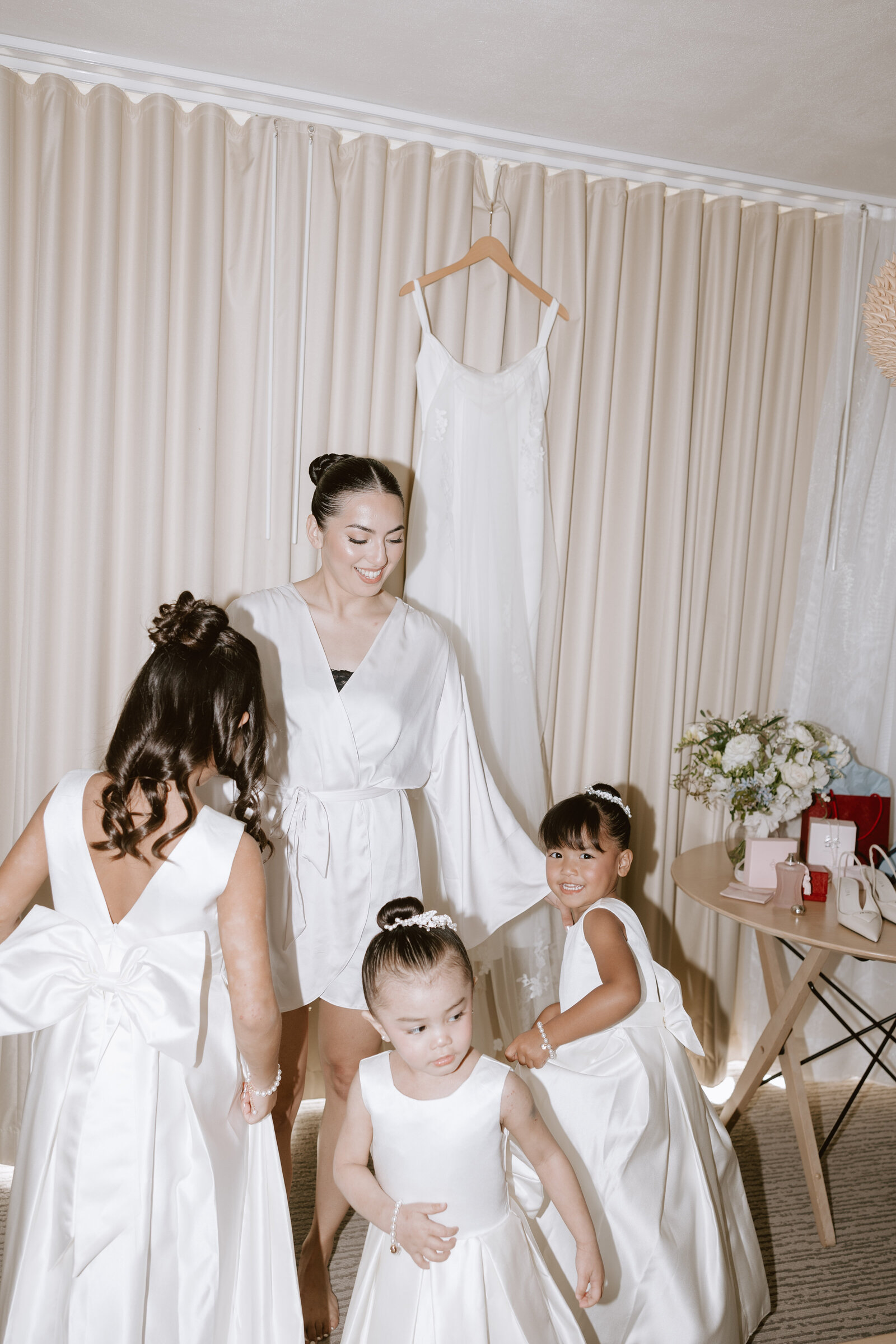 Getting ready in hotel room bride with her junior bridesmaids dancing