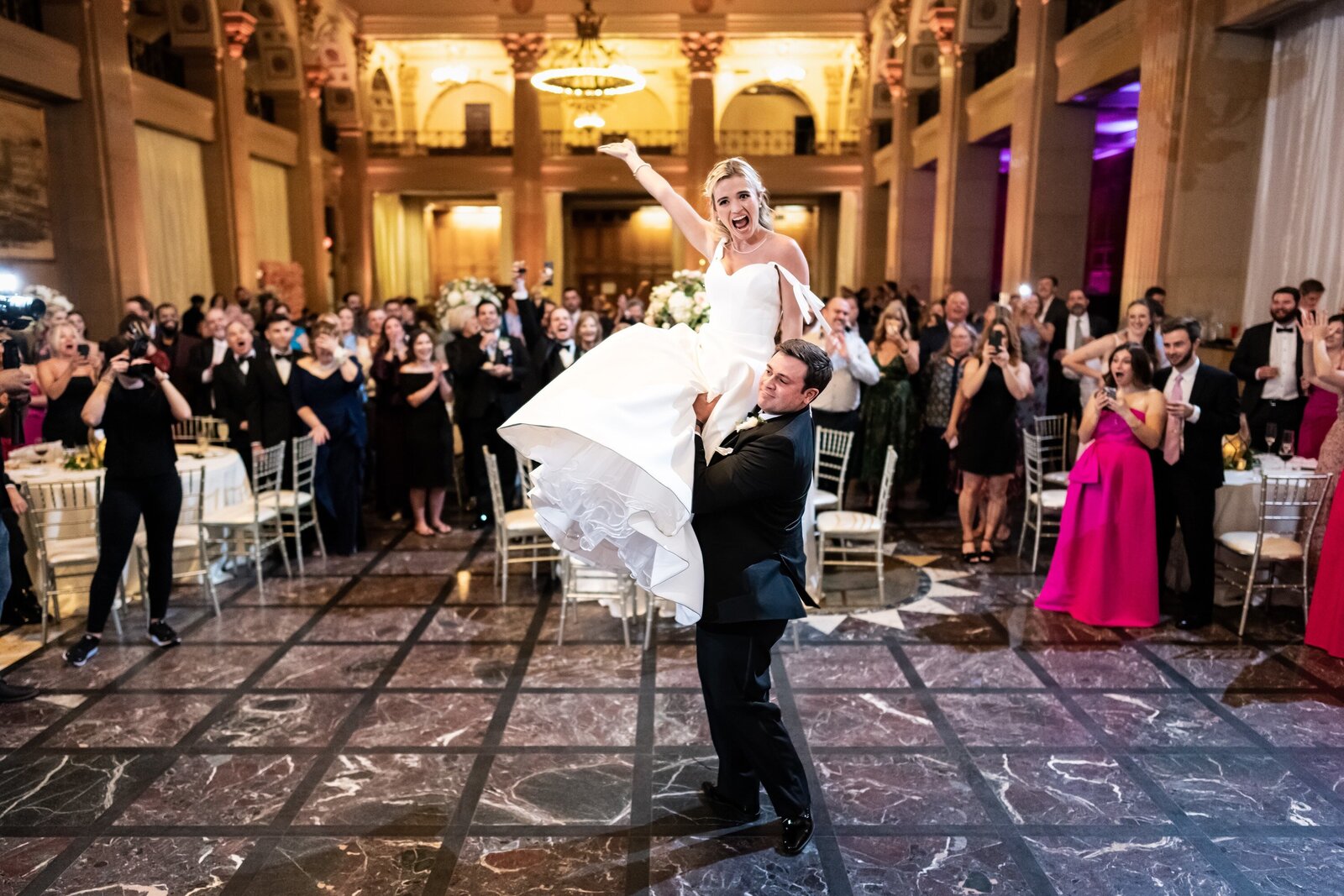 Groom lifts bride at Capital on Baronne wedding reception