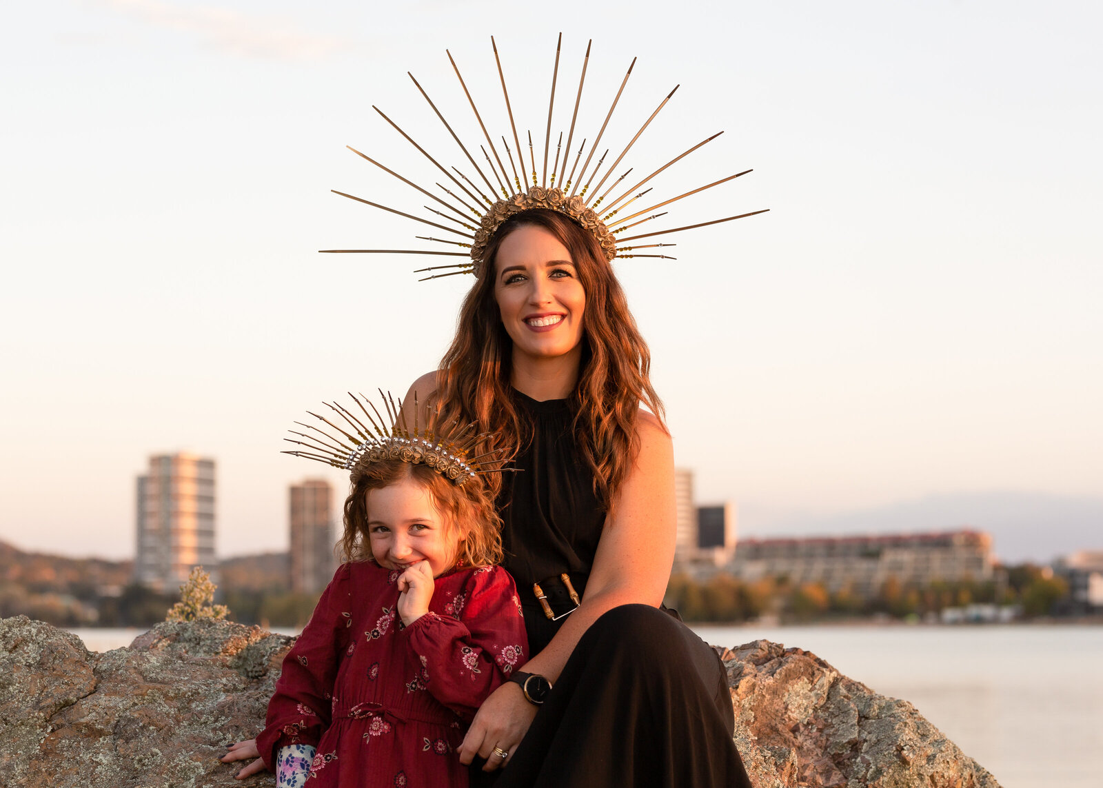 Mother and giggling daughter in head-dress