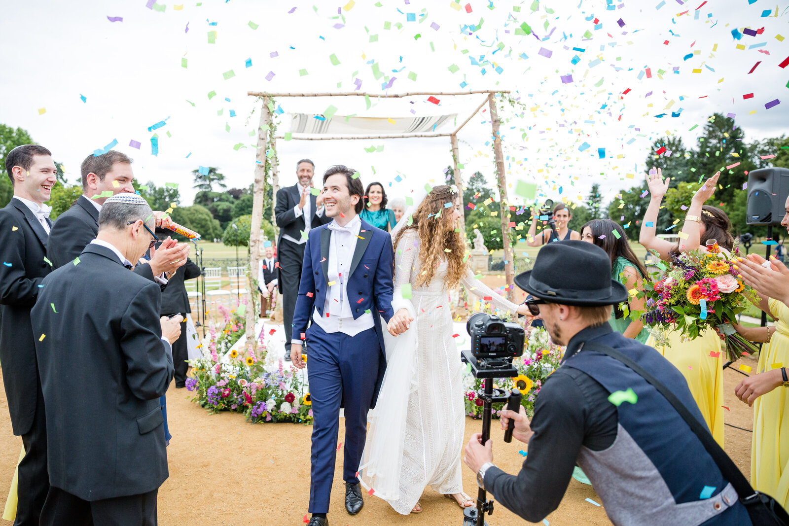The Bride and Groom leave the ceremony as guests throw confetti