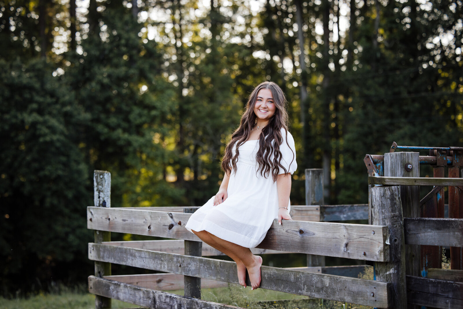 girl-sitting-on-fence-pasture-senior-pictures