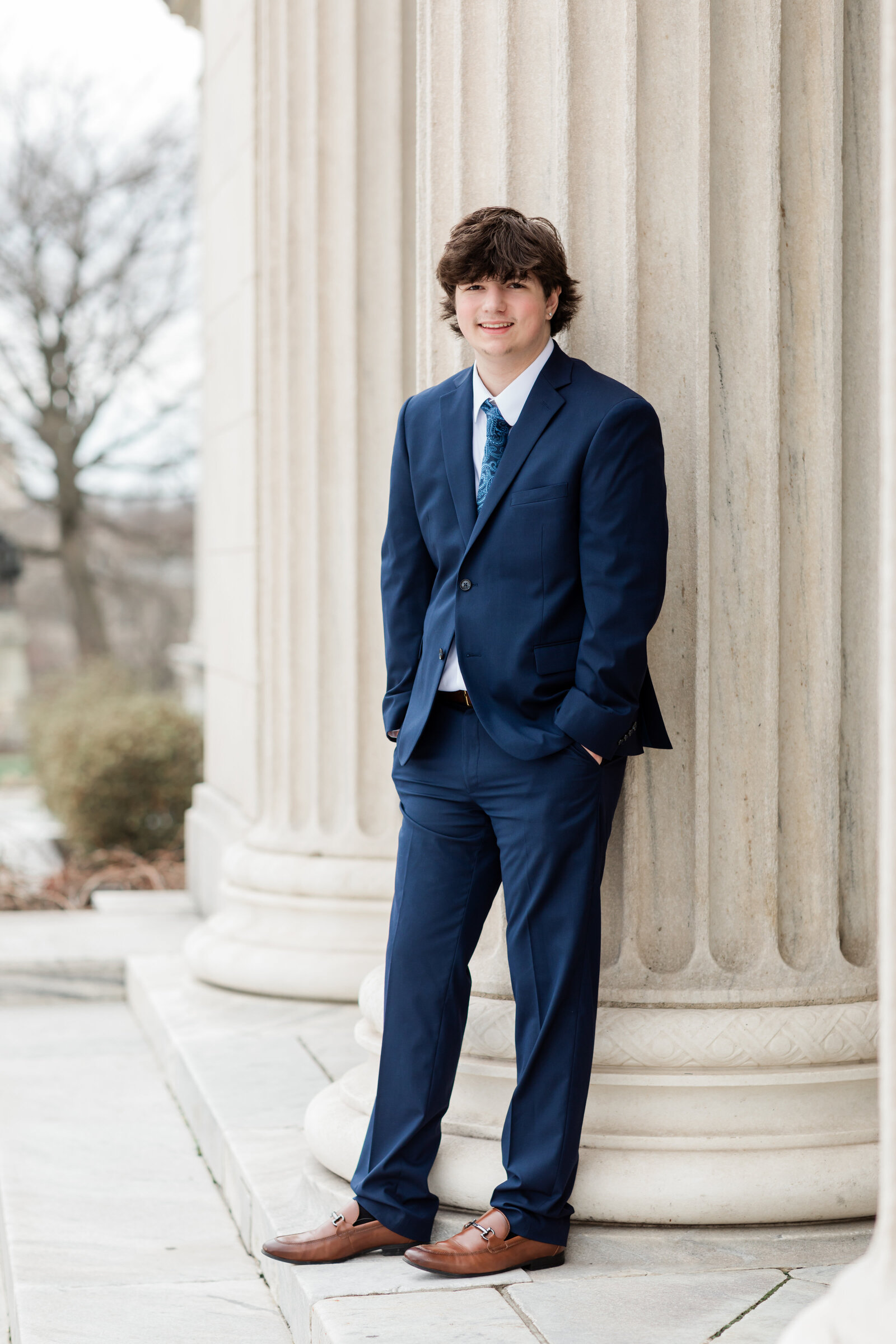 high school senior boy in blue suit posed at Cleveland Museum of Art for portraits Cleveland senior photographer
