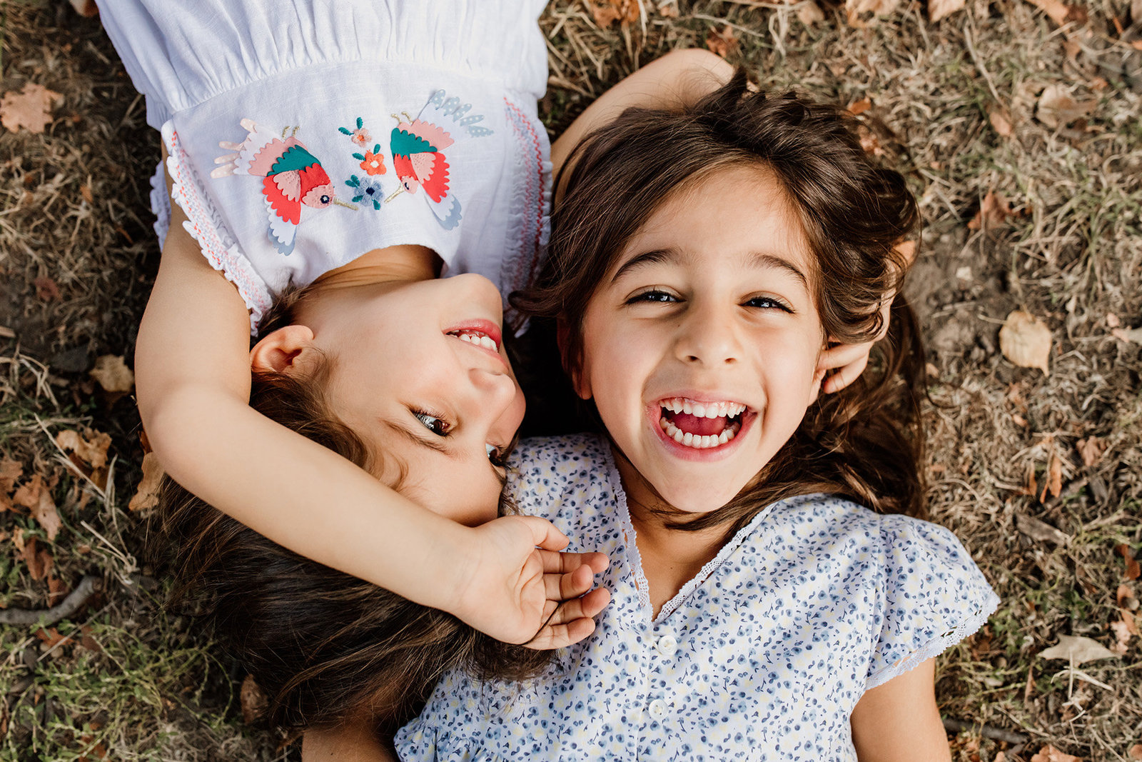 two sisters lying in the grass