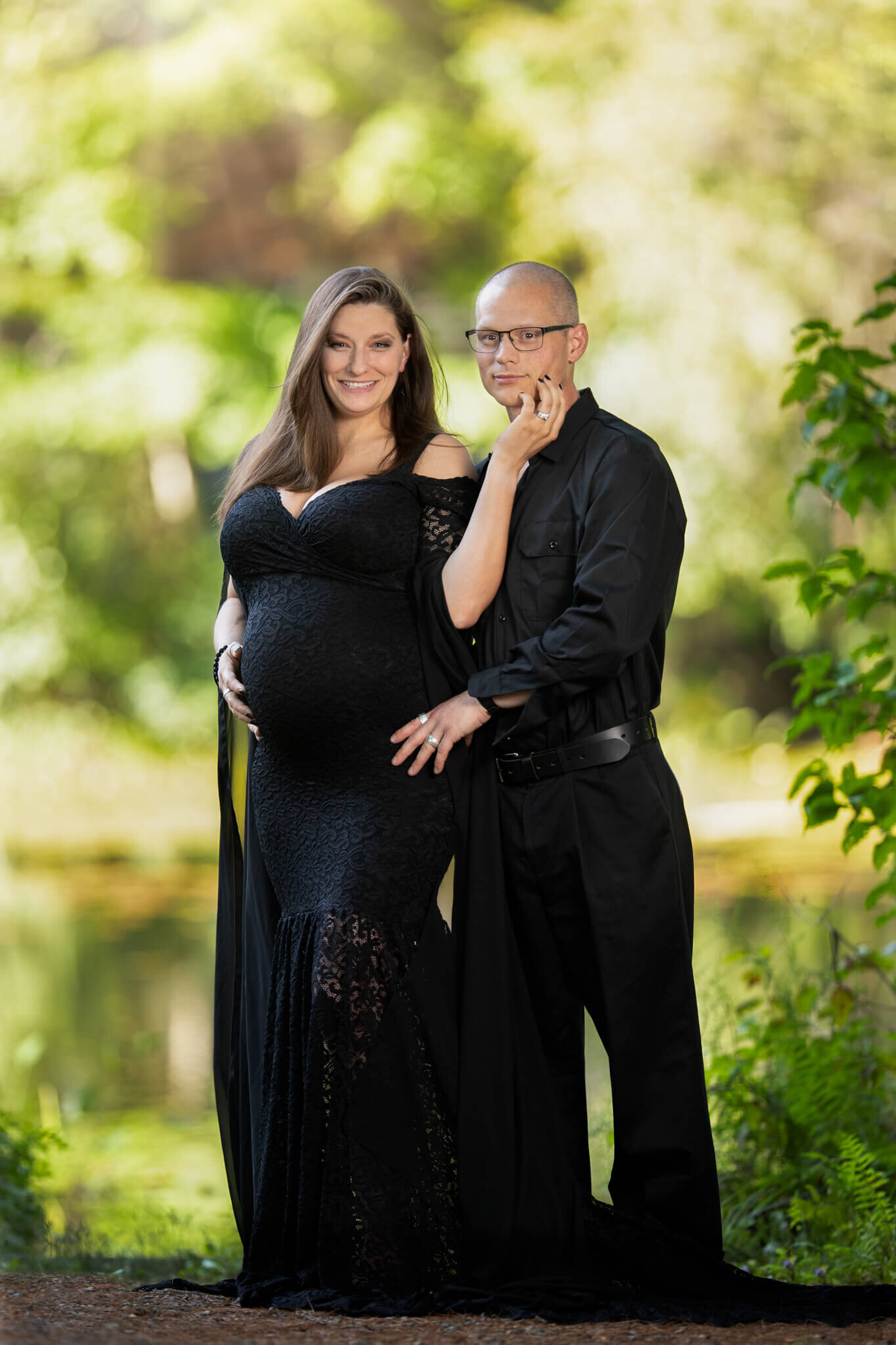 Maternity photo of mother and father  both wearing black