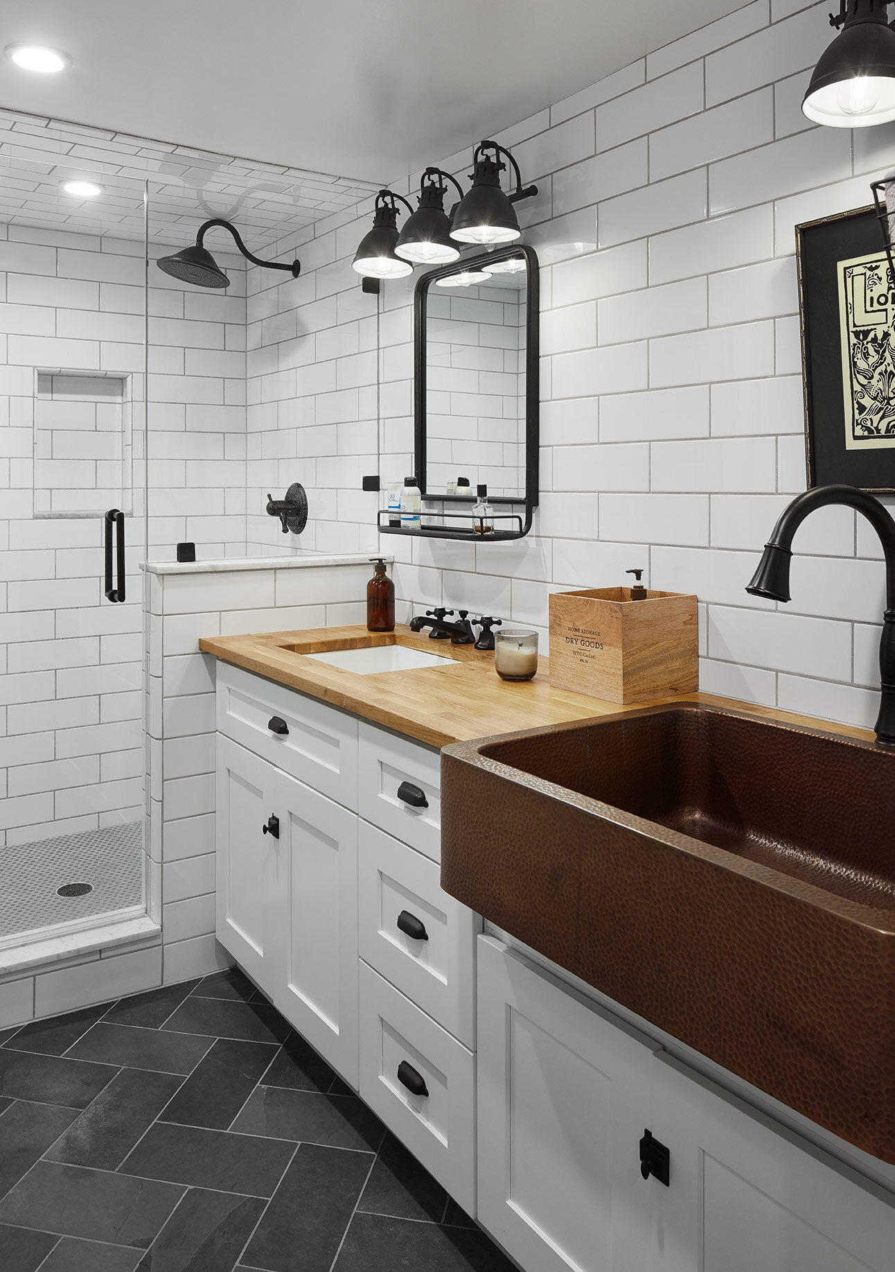 Farmhouse style sink in a white bathroom with subway tile
