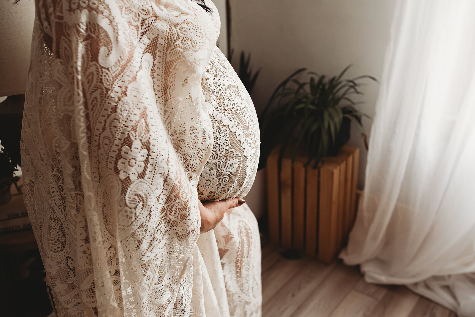 Wrapped in a lace dressing gown from the Nikii Pix Client Closet, a momma embraces her growing bump while feeling empowered.
