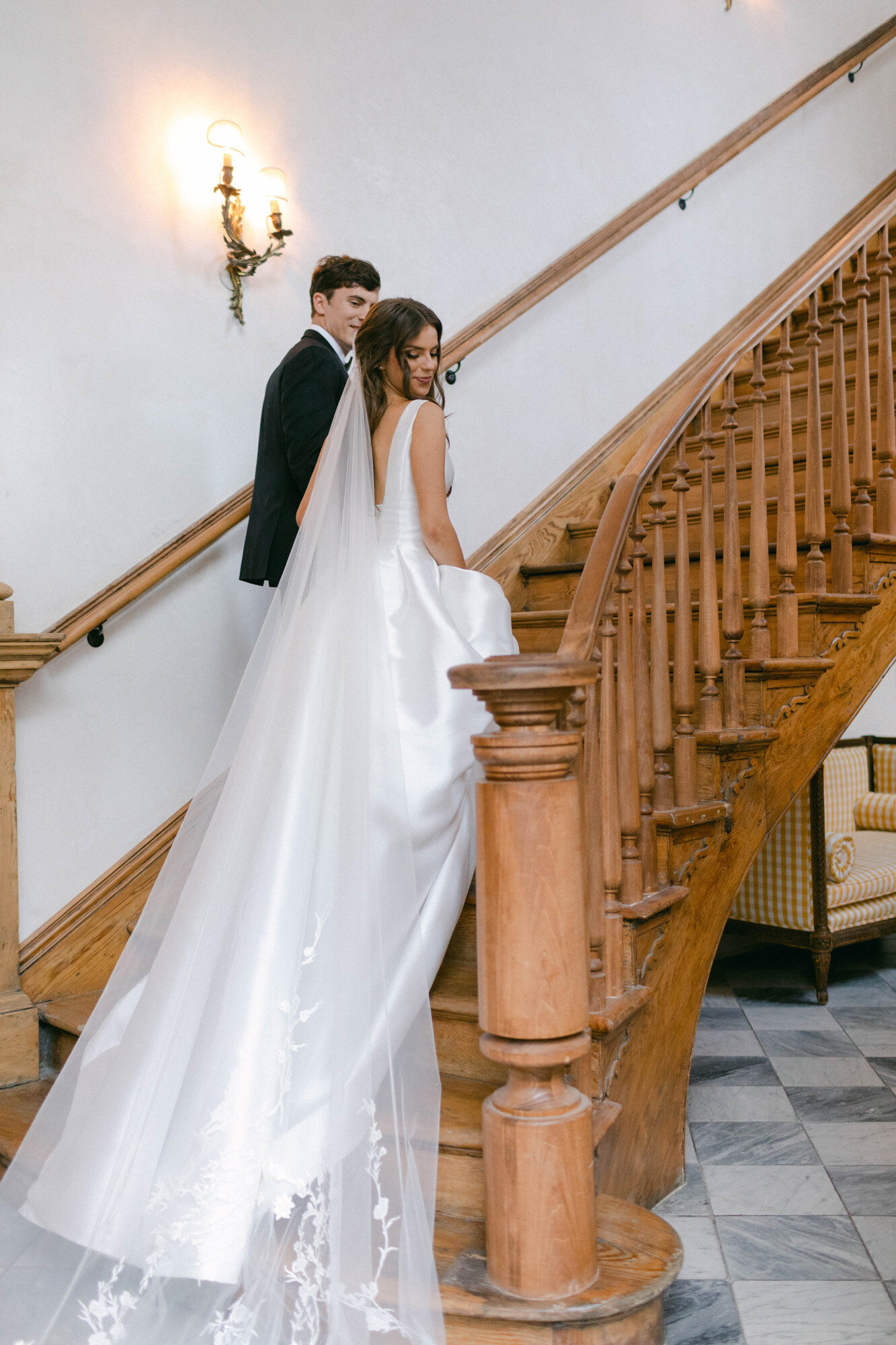 bride and groom walking up stairs