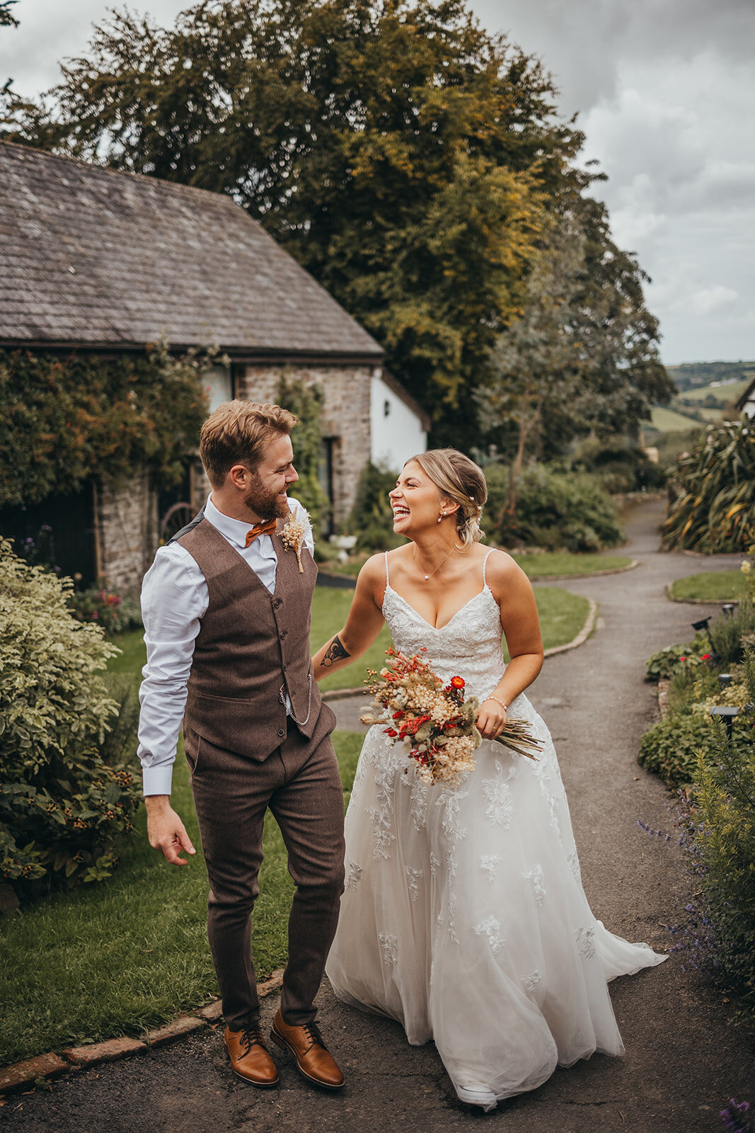 bride and groom laugh at eachother