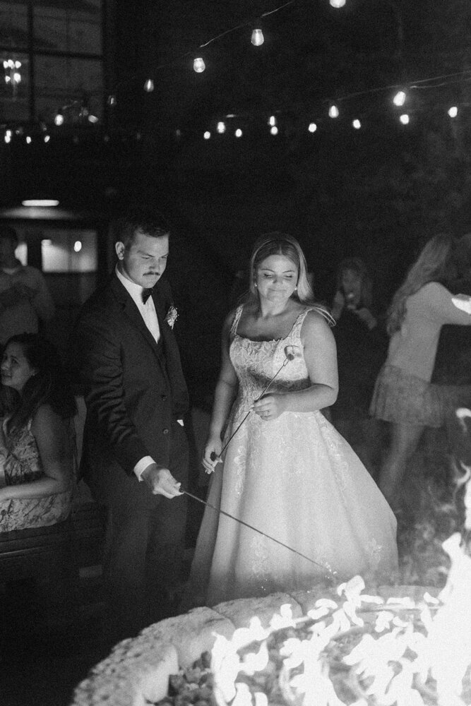 bride and groom roasting smores