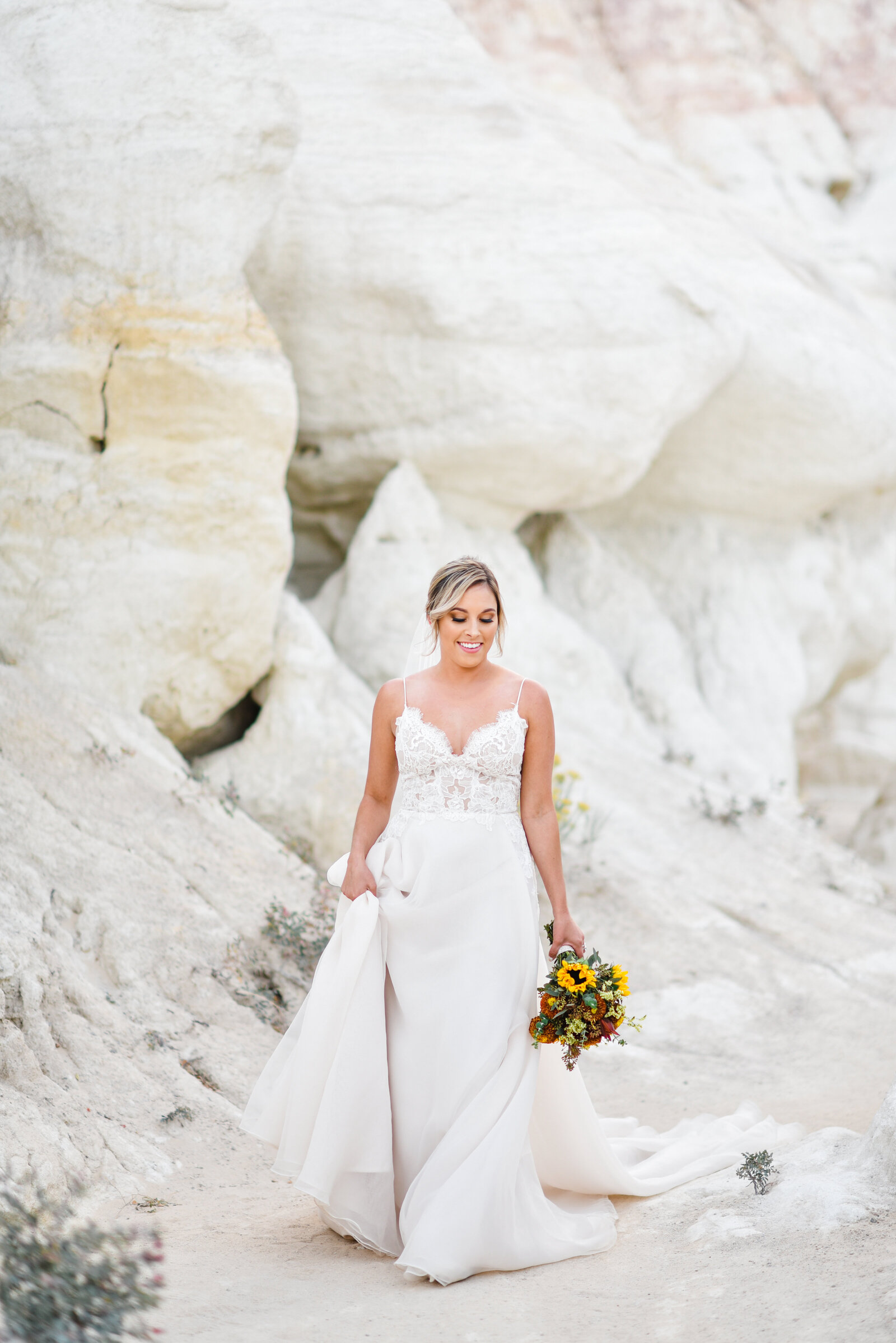 Colorado Wedding Photographer captures bride walking through paint mines in dress