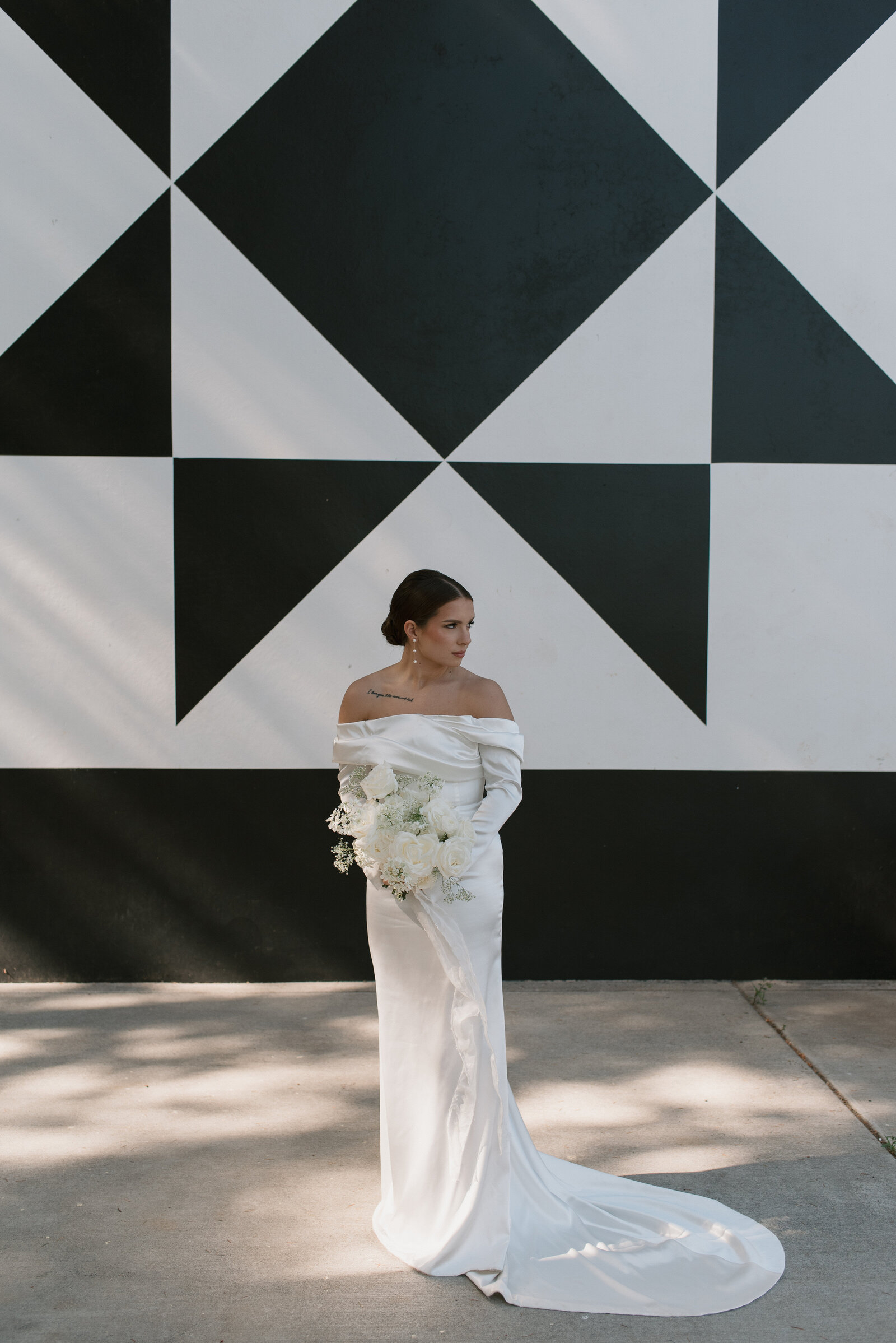 romantic bride in front of a black and white wall