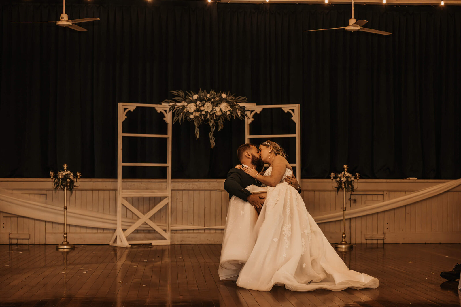 The bride and groom embrace during their first dance, radiating love and happiness on their special wedding day.