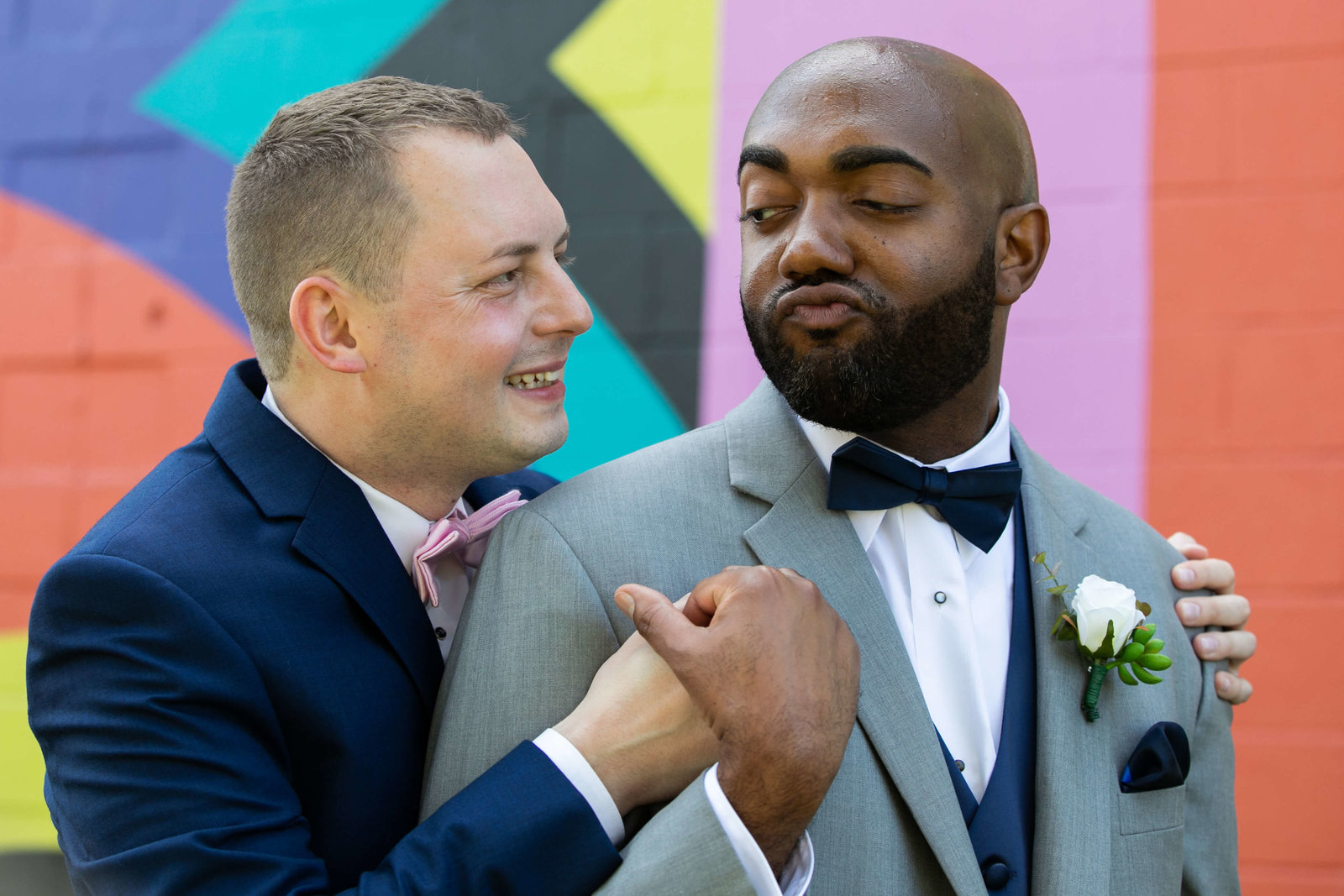 Grooms in matching grey and navy blue tuxes