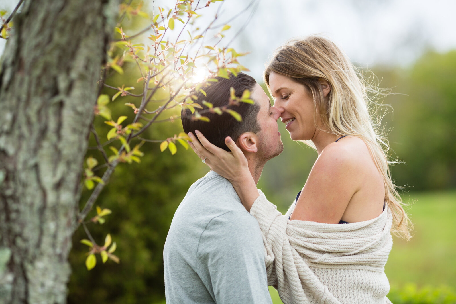 newport-vineyard-engagement-couple-embraces-under-tree-lisa-gilbert-photography