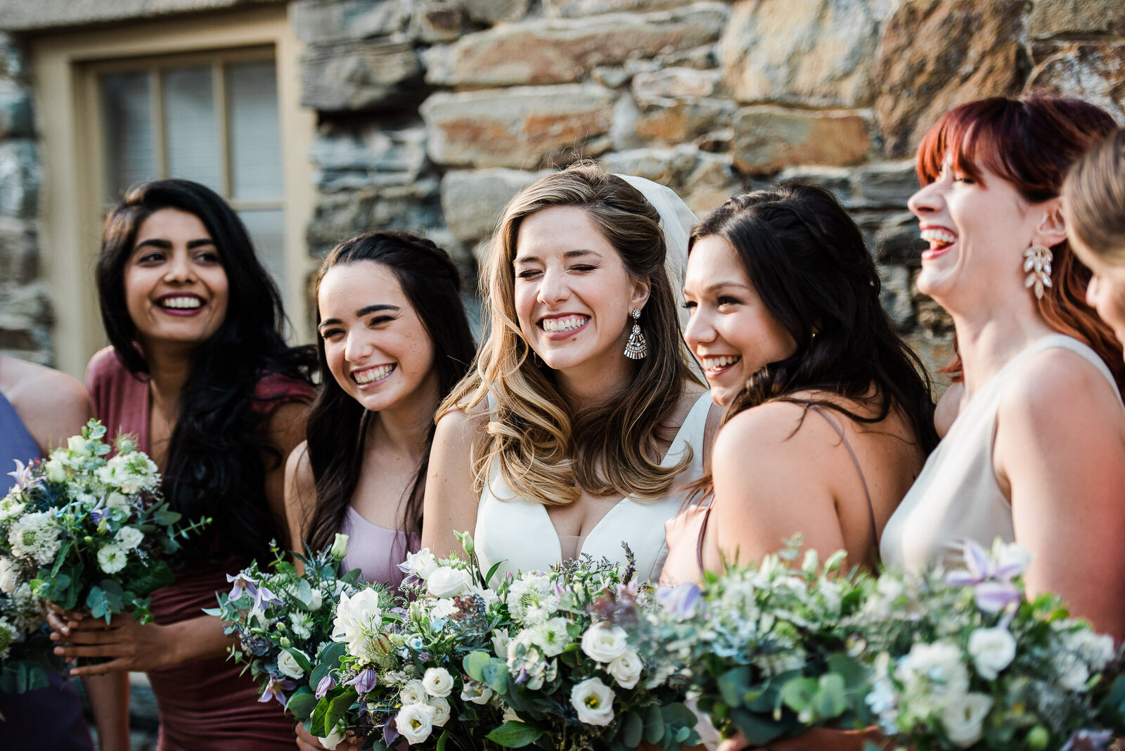 bride and bridesmaids laughing