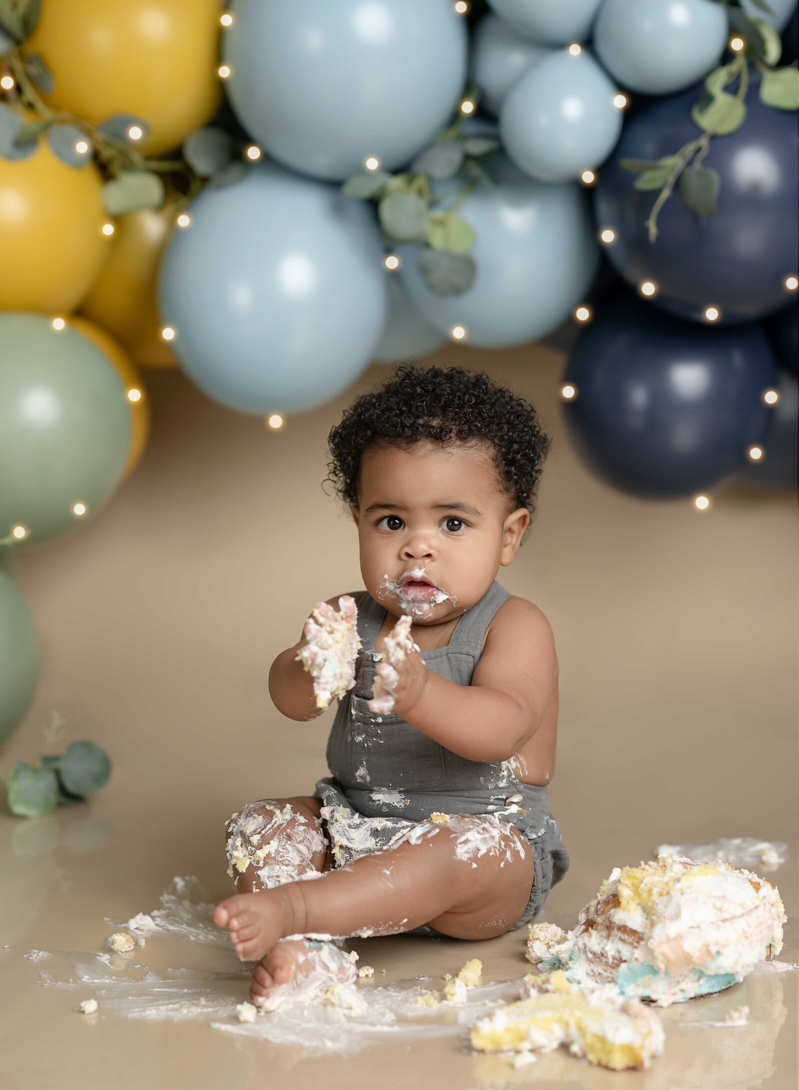 cake smash photo of baby playing with cake. Cake smash photo taken by Jenni Nikki Photography in Atlanta, GA.