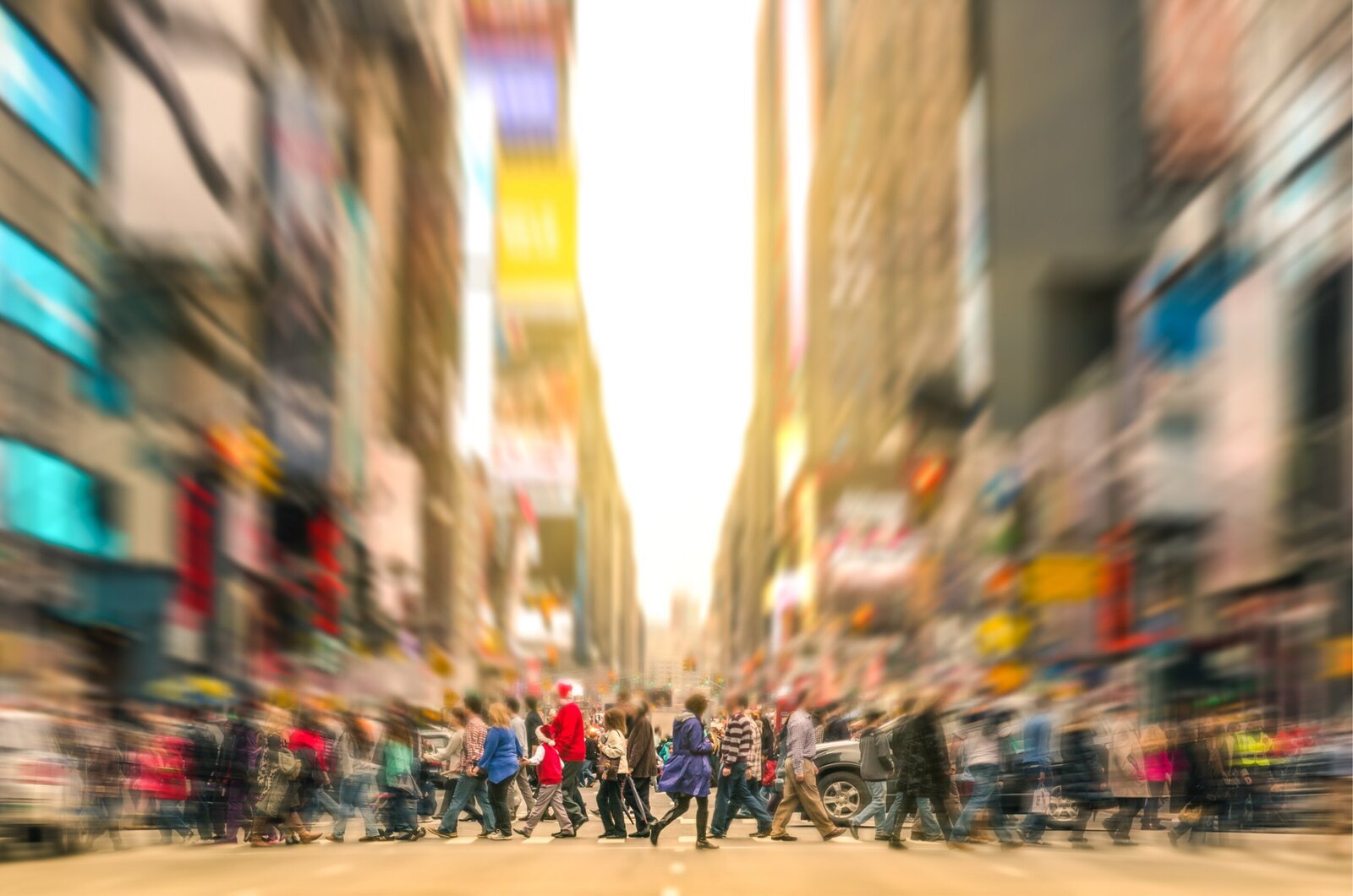 image of large group walking across crosswalk in a big city