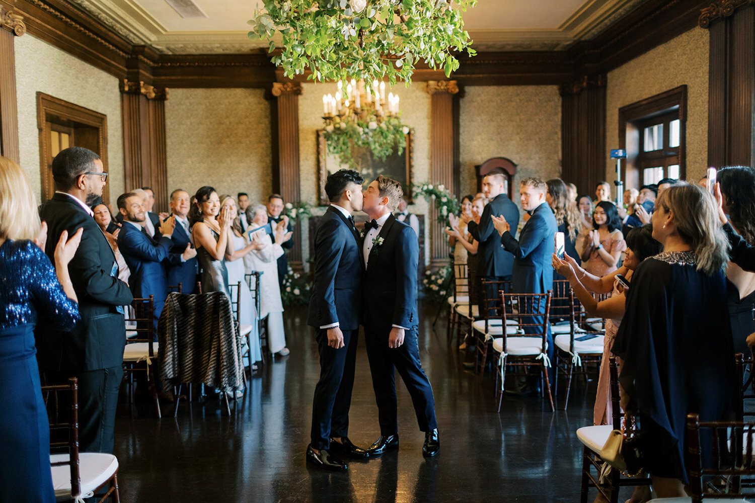 Two grooms kissing at ceremony in the Bay Area