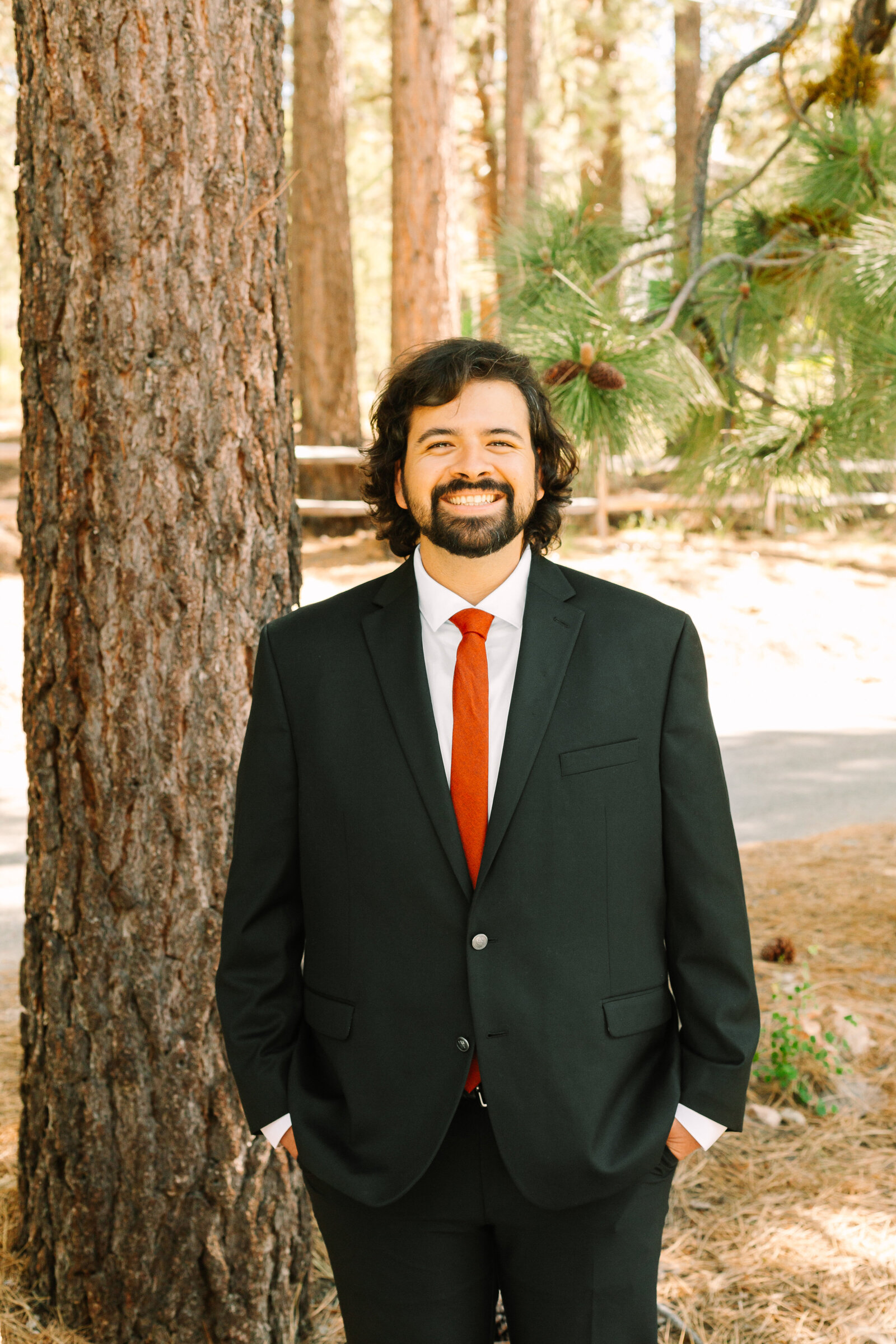 A groom celebrates his intimate elopement at a cabin at Big Bear Lake, California.