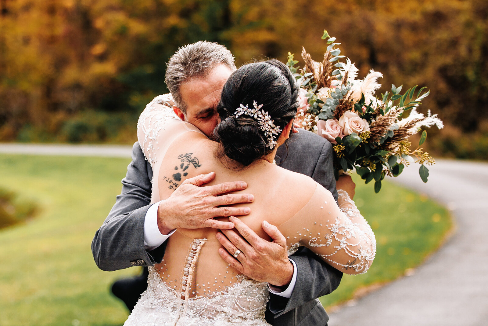 Father embraces bride after seeing her for the first time in her wedding dress