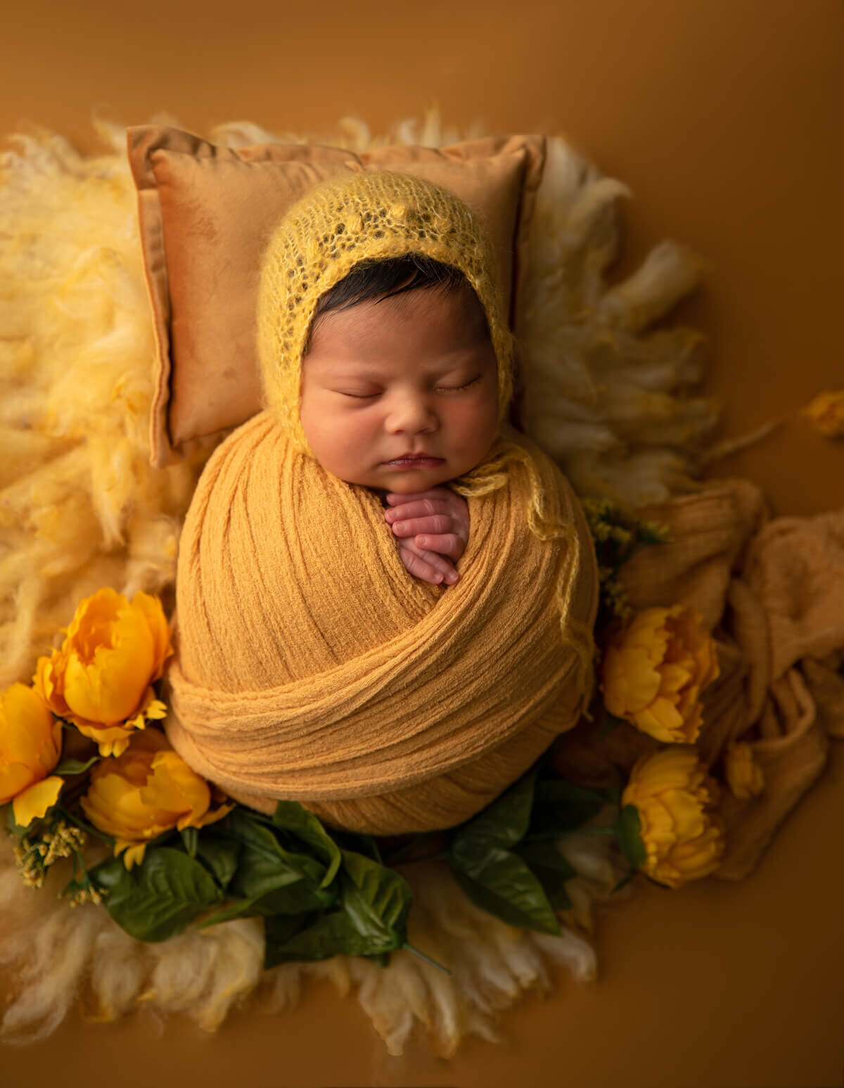 newborn wrapped in yellow