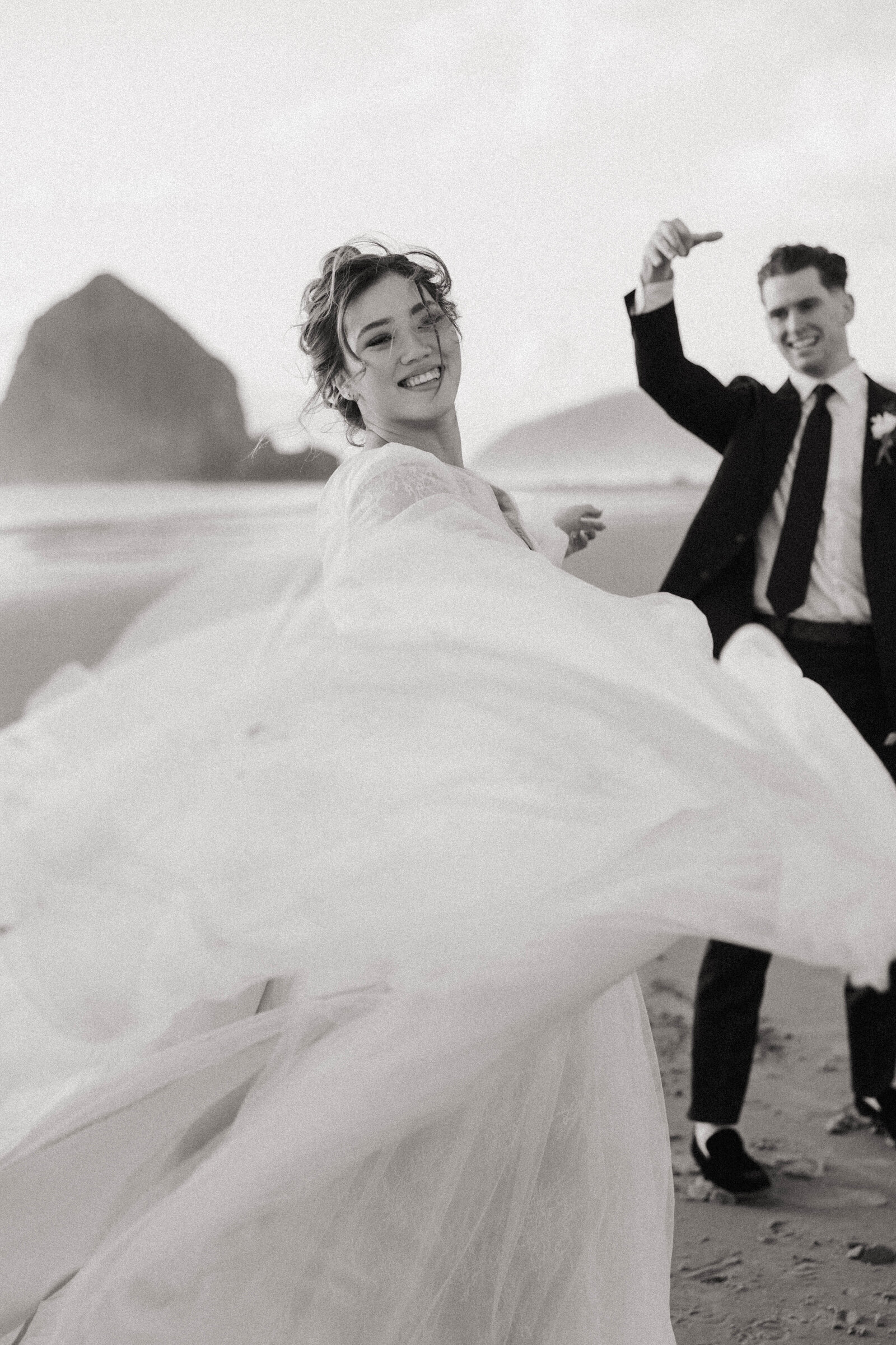 A couple giggling and laughing in Oregon with their elopement photographer.