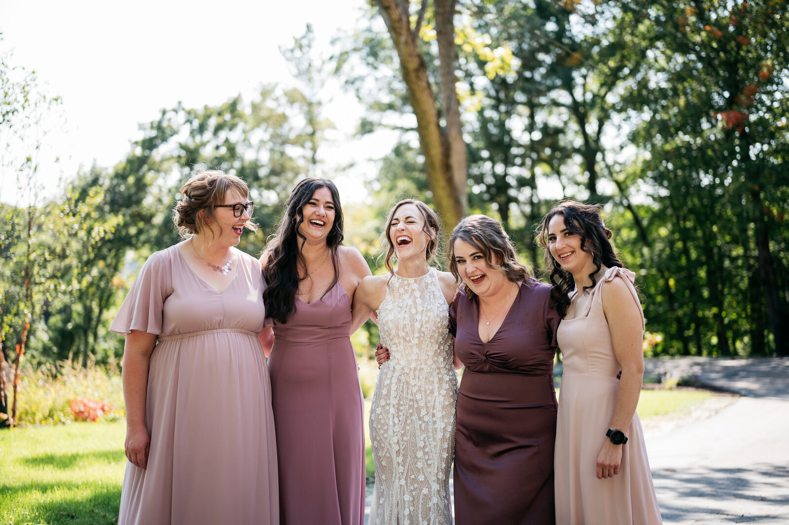 bride-bridesmaids-mauve-outside-laughing