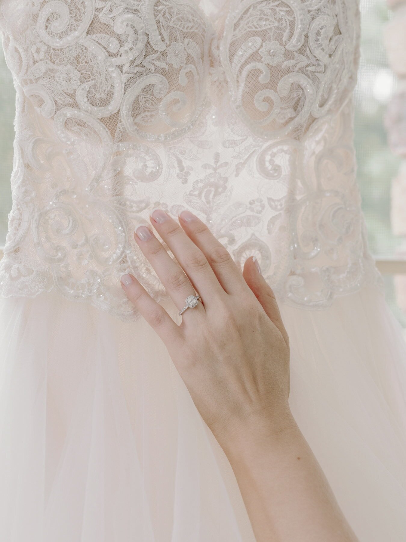Bride is touch bodice of her Oksana Mukha wedding gown