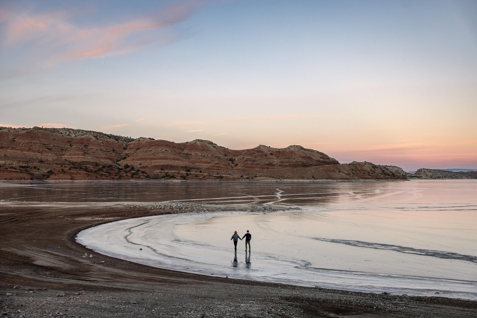winter engagements on a lake at sunset