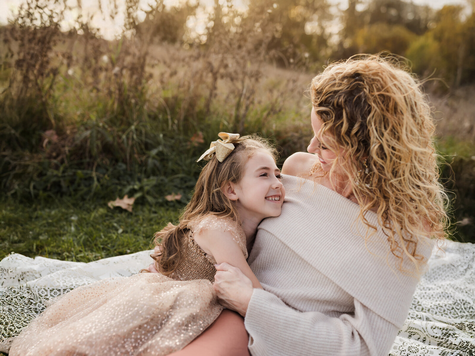 mother and daughter sitting on lace blanket for family photos at Allaradale Park in Medina, Oh Cleveland family photography