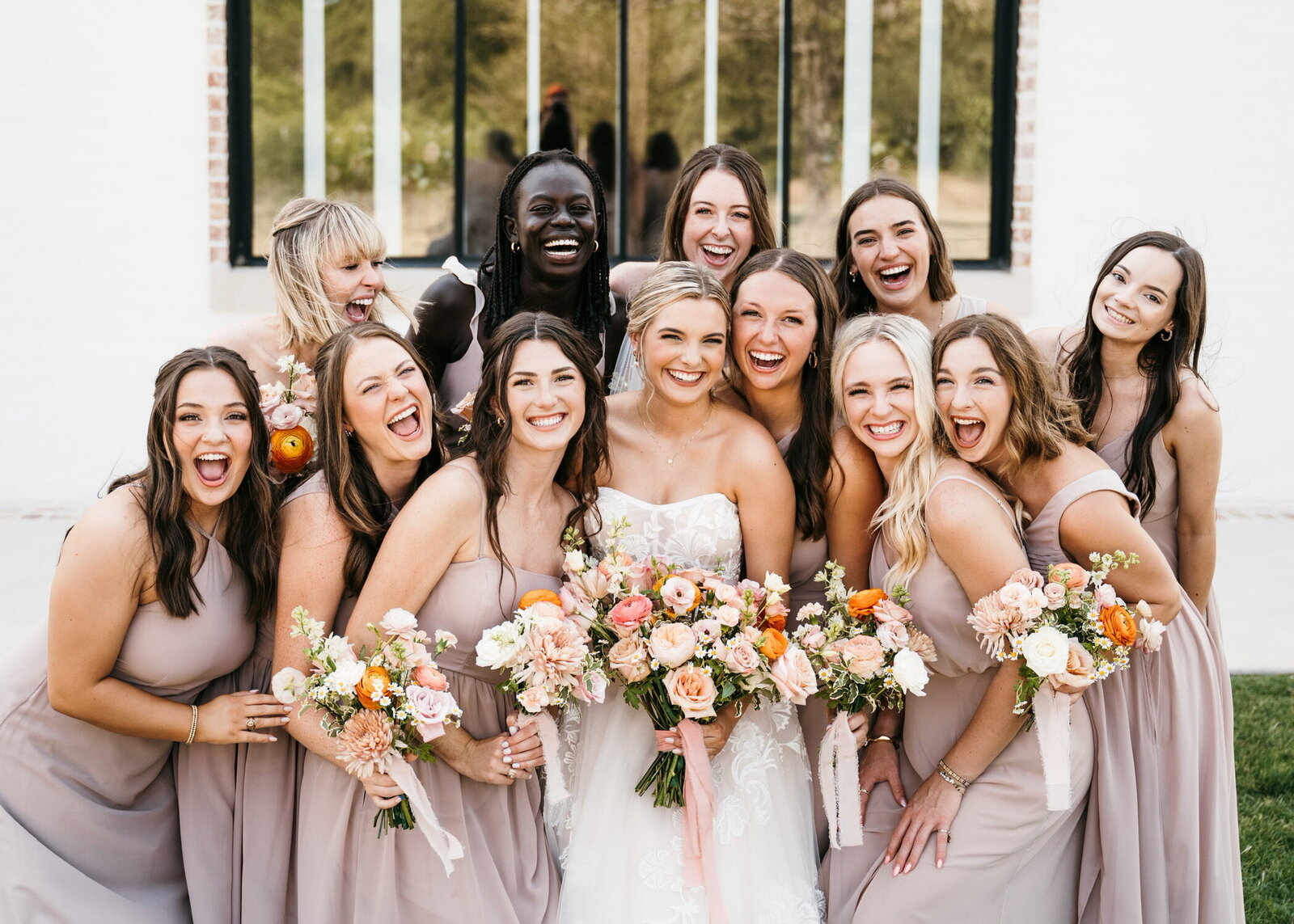 Bridesmaids and brides in wedding attire hold bouquets in Houston Texas.