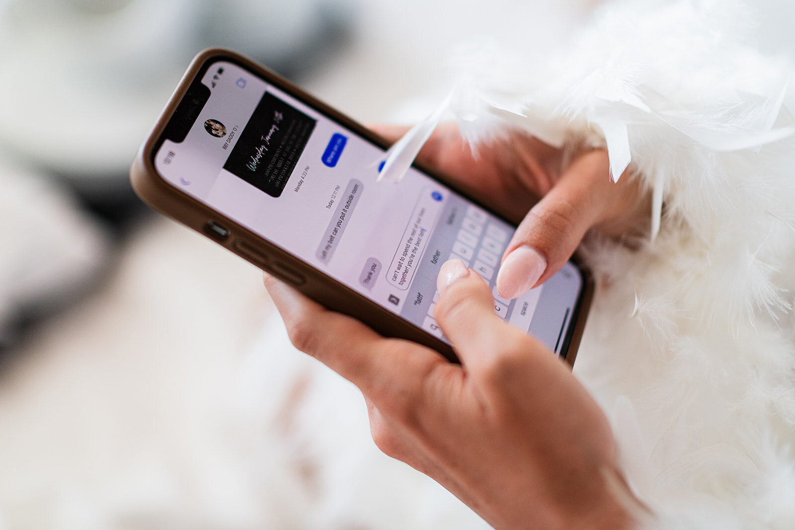 A close-up of the bride holding her phone with wedding details displayed, captured in a candid moment by CMH Studios.