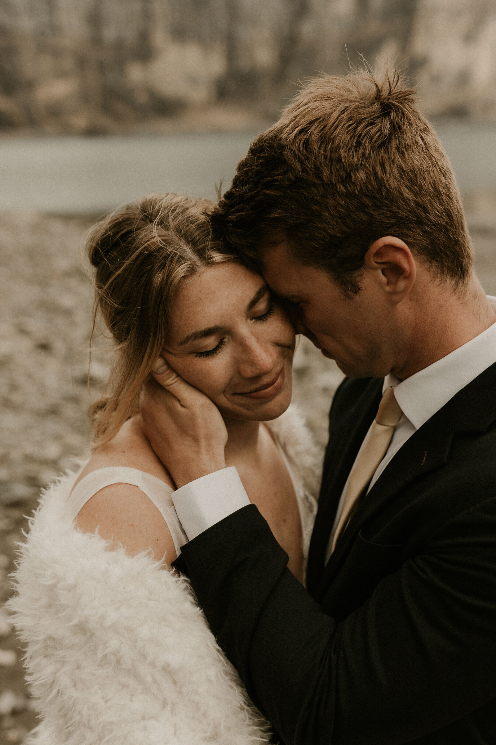 close up on groom nuzzling bride during elopement at Oeschinensee Lake in Switzerland