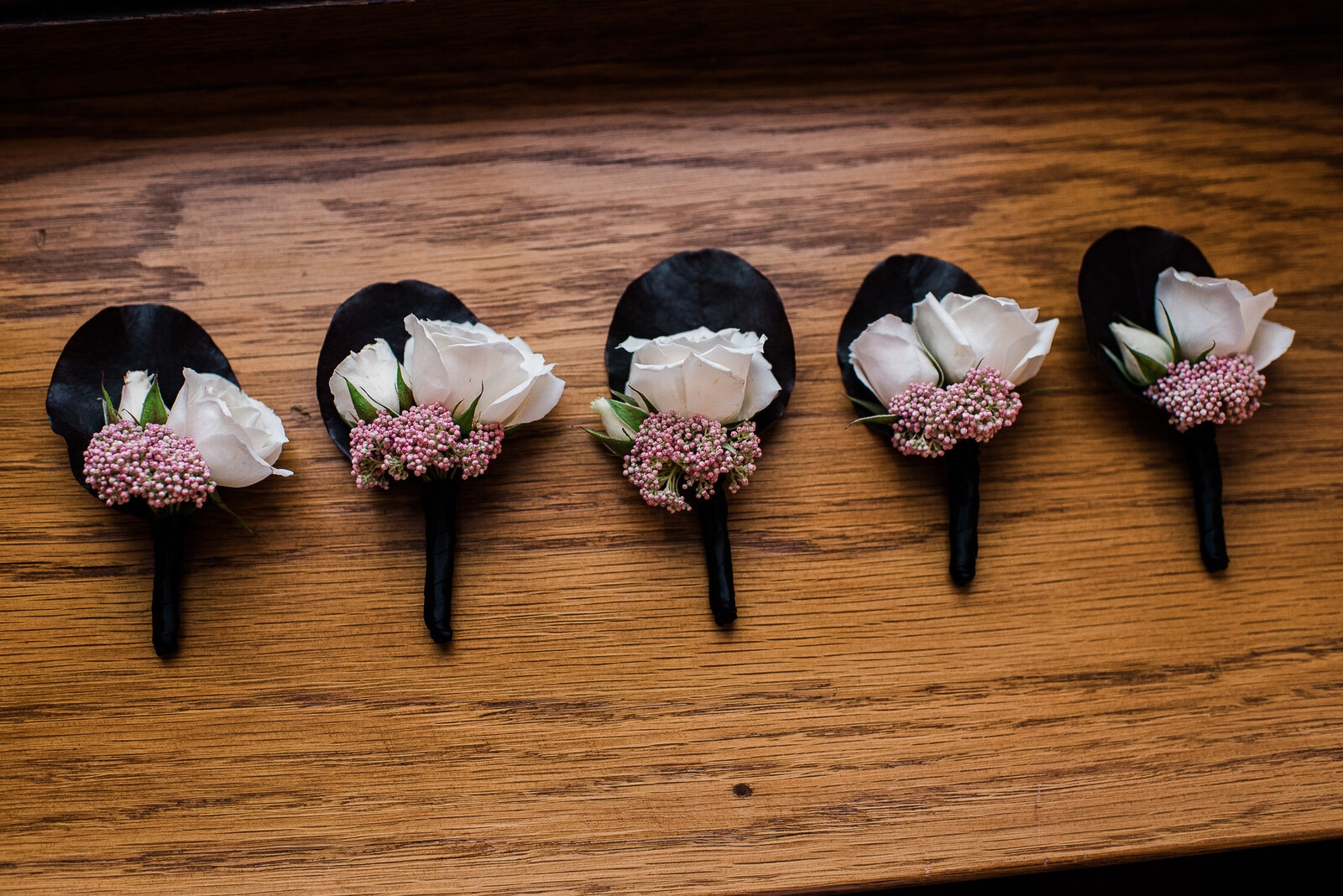 boutonnieres on wood surface