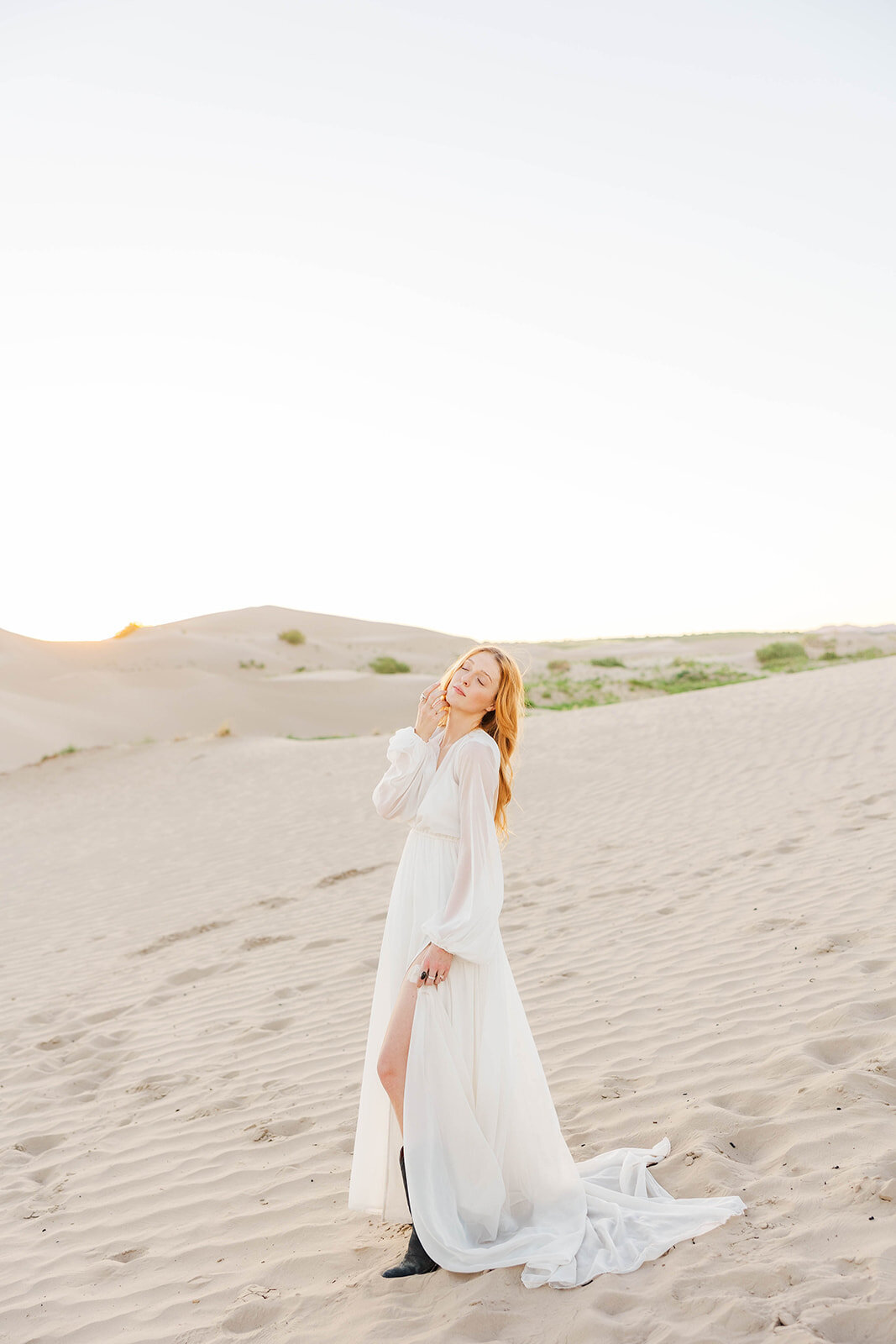 Bride posing at her elopement at the Little Sahara Sand Dunes in Utah.
