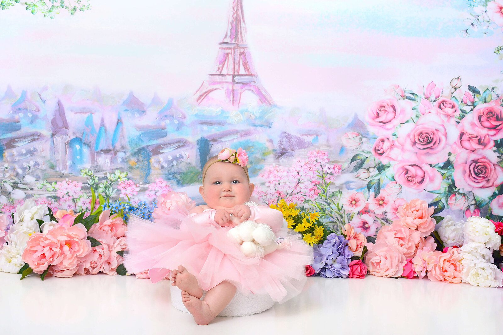 girl smiles at her paris themed half birthday photoshoot