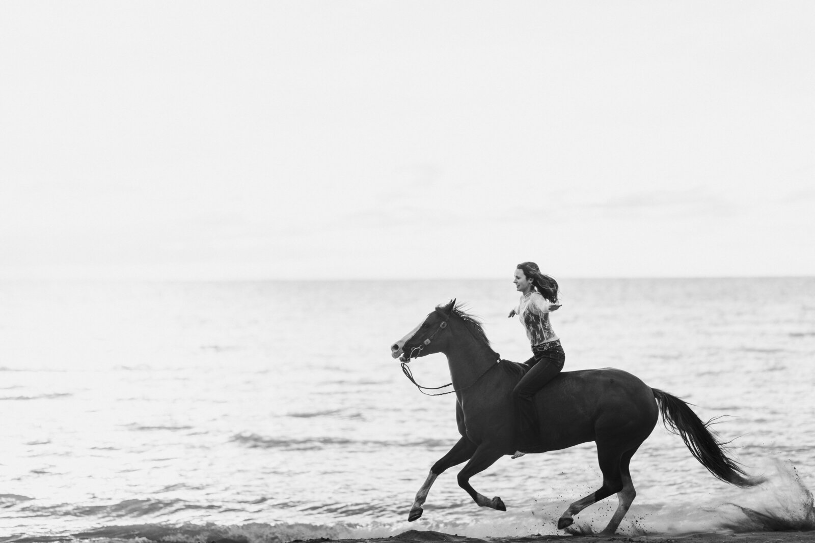 a girl riding her horse bareback at the beach