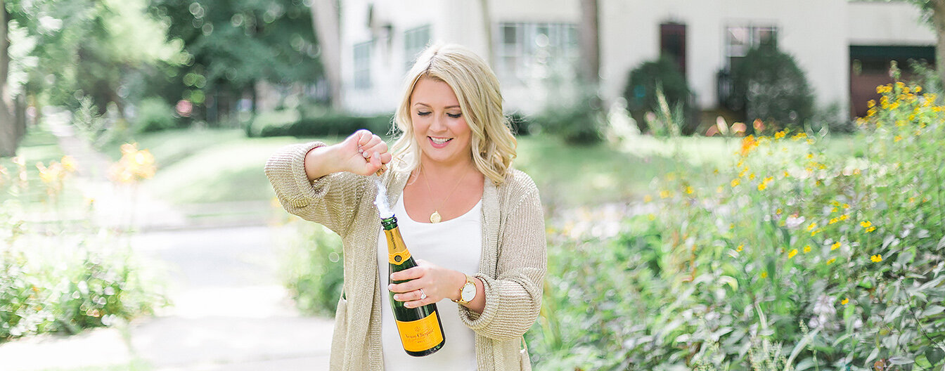 woman business owner CEO popping champagne celebrating entrepreneur