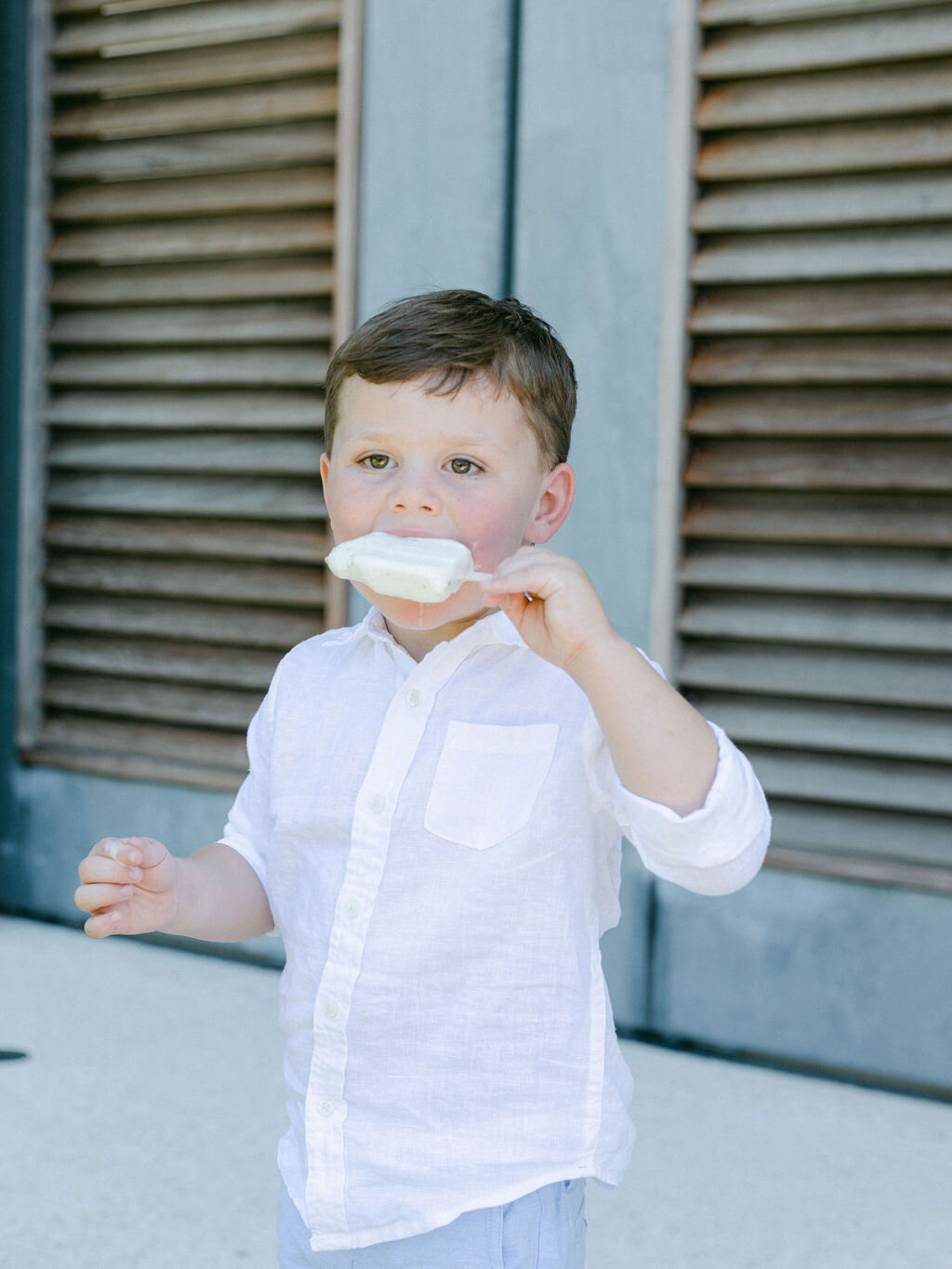Boy eating an ice cream at summer wedding at Rosemary beach Florida