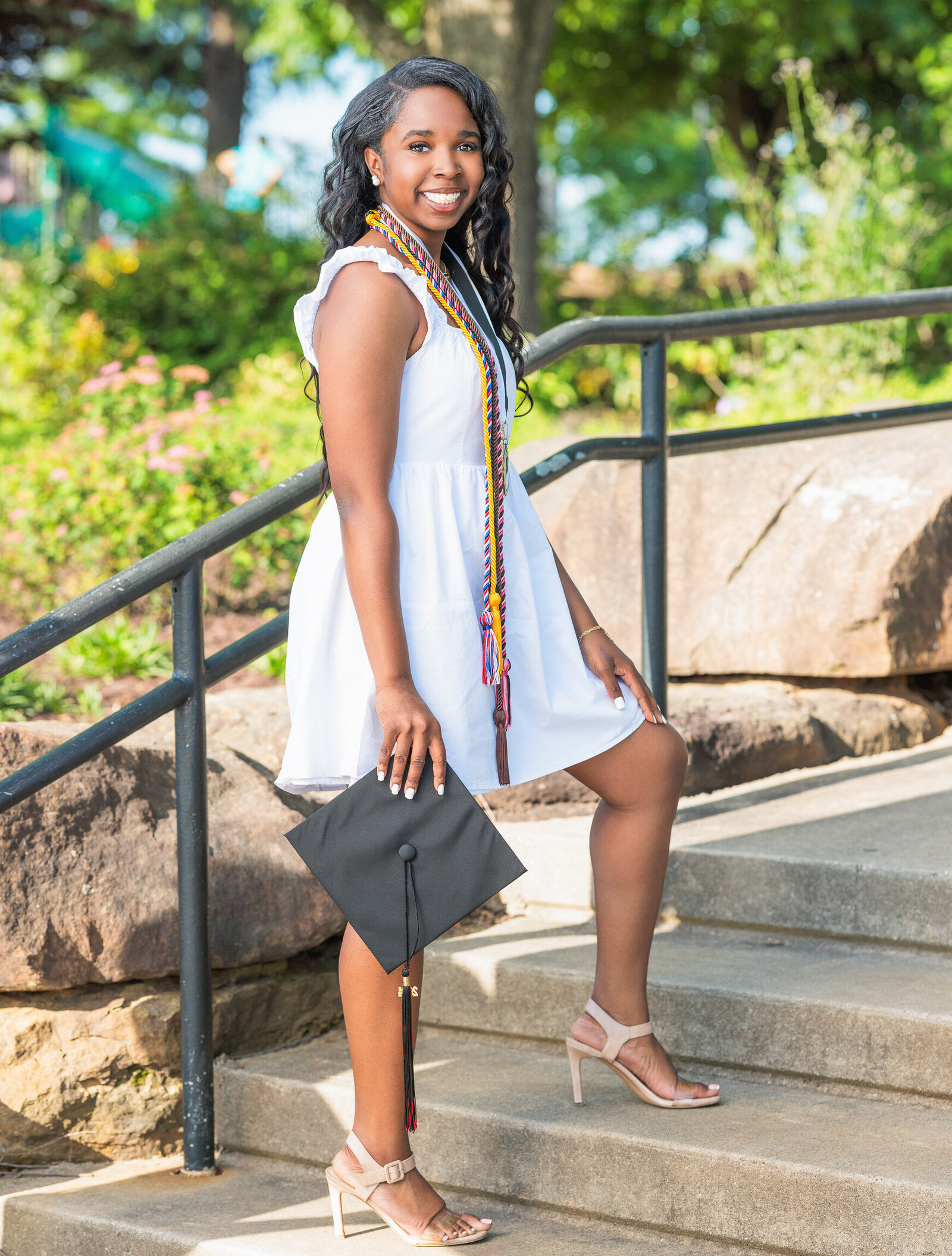 Seior in white dress holding cap