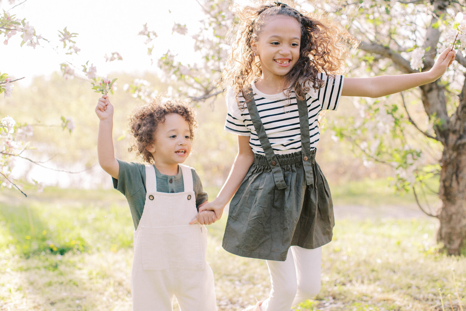 Bright sunny dancing playing kids family photos at Cider Hill Family Orchard