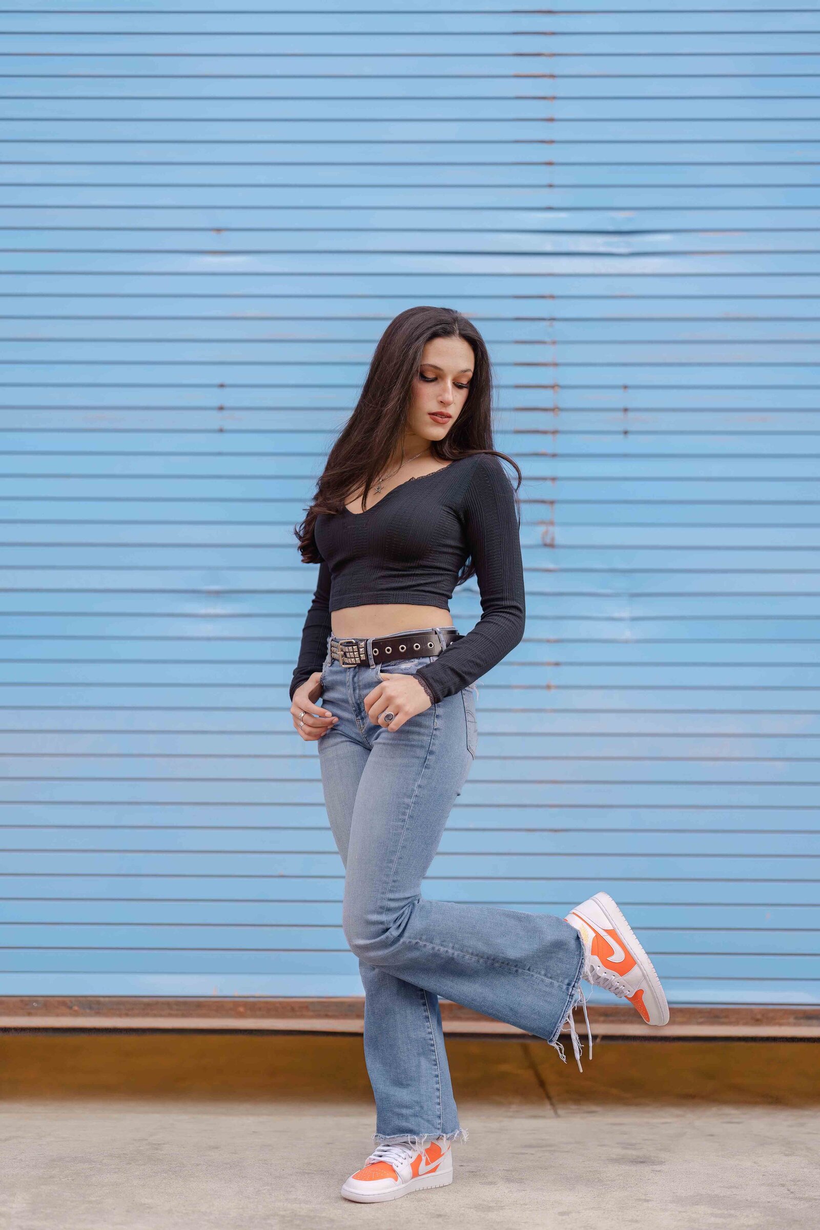 girl looking at her sneakers during Reston, Virginia senior photography