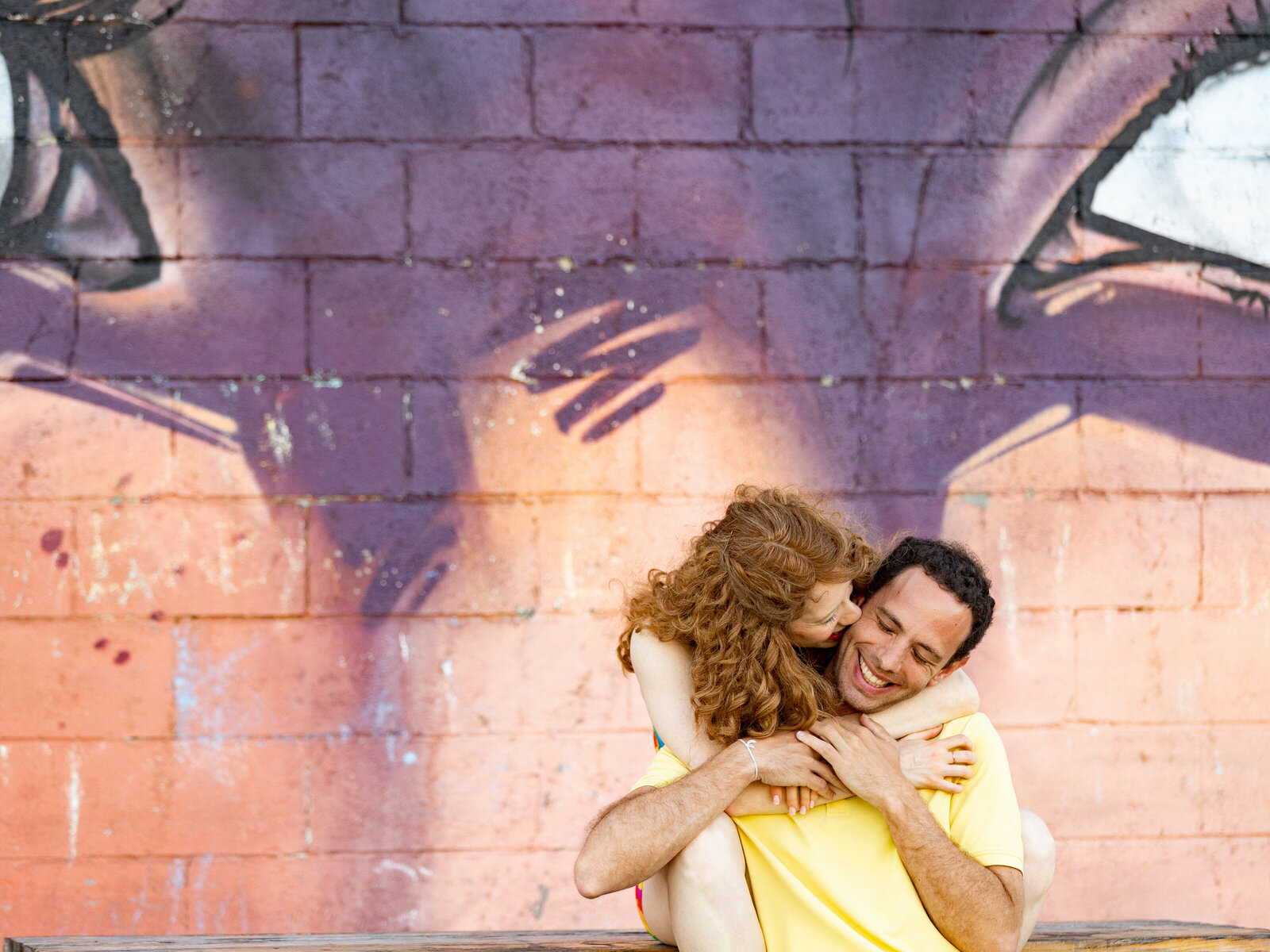 couple-embraces-by-mural-engagement-lisa-gilbert-photography