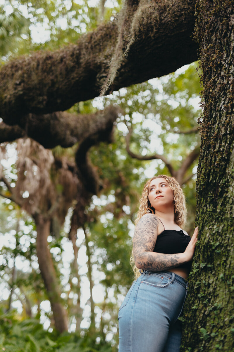 Gorgeous woman leaning against a tree for a branding session in st pete