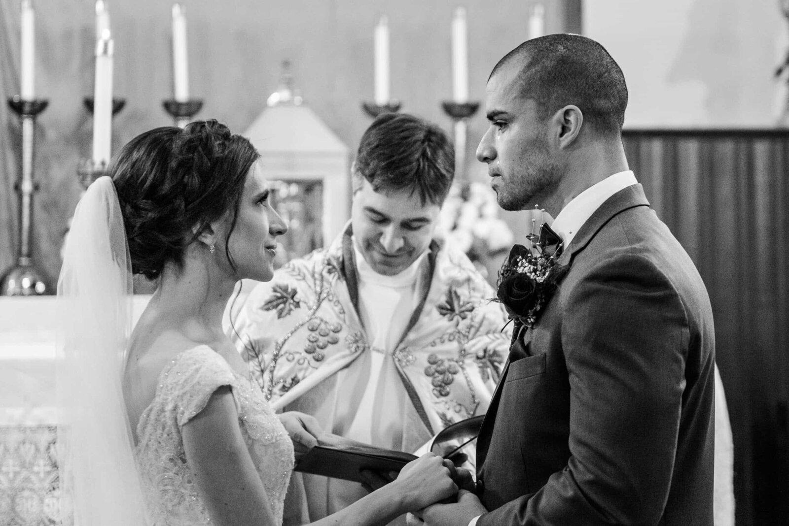 A groom sheds a tear during his  vows at a Catholic wedding in Northern Virginia