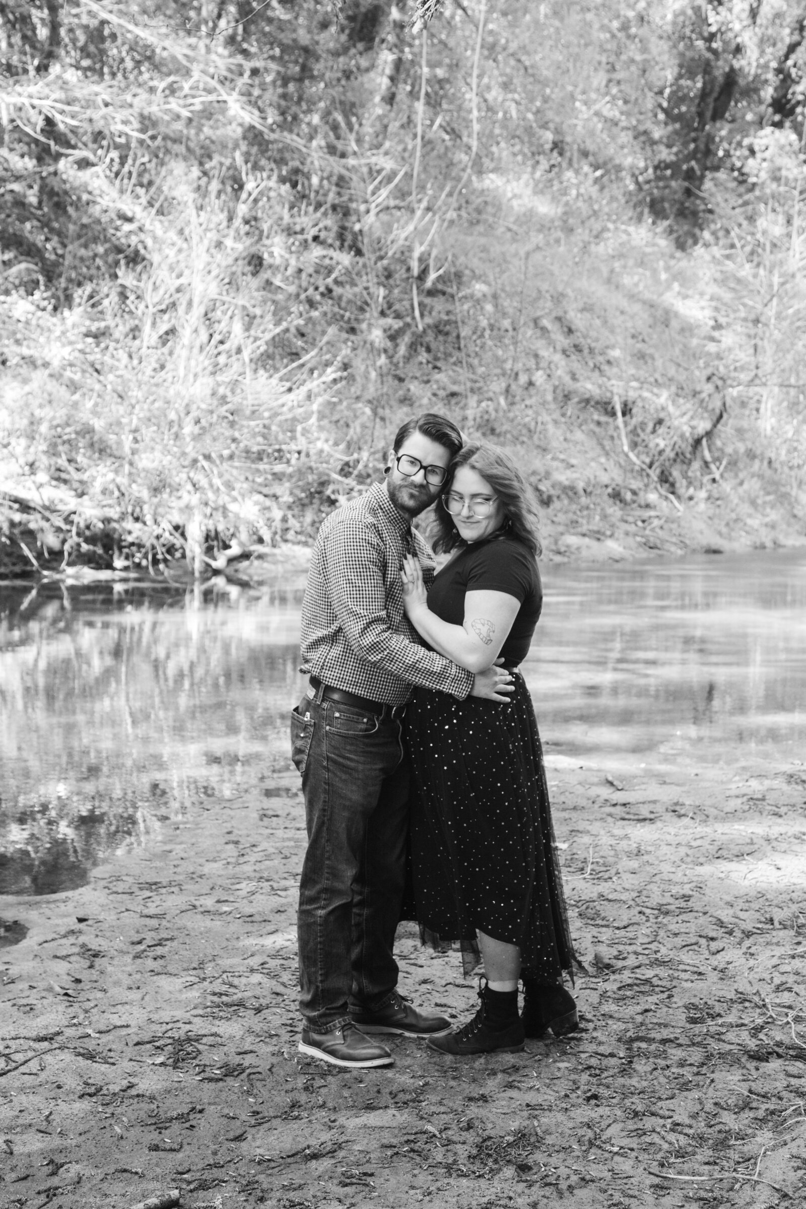 An tattooed engaged couple poses for photos in a redwood forest in Santa Cruz, Ca.