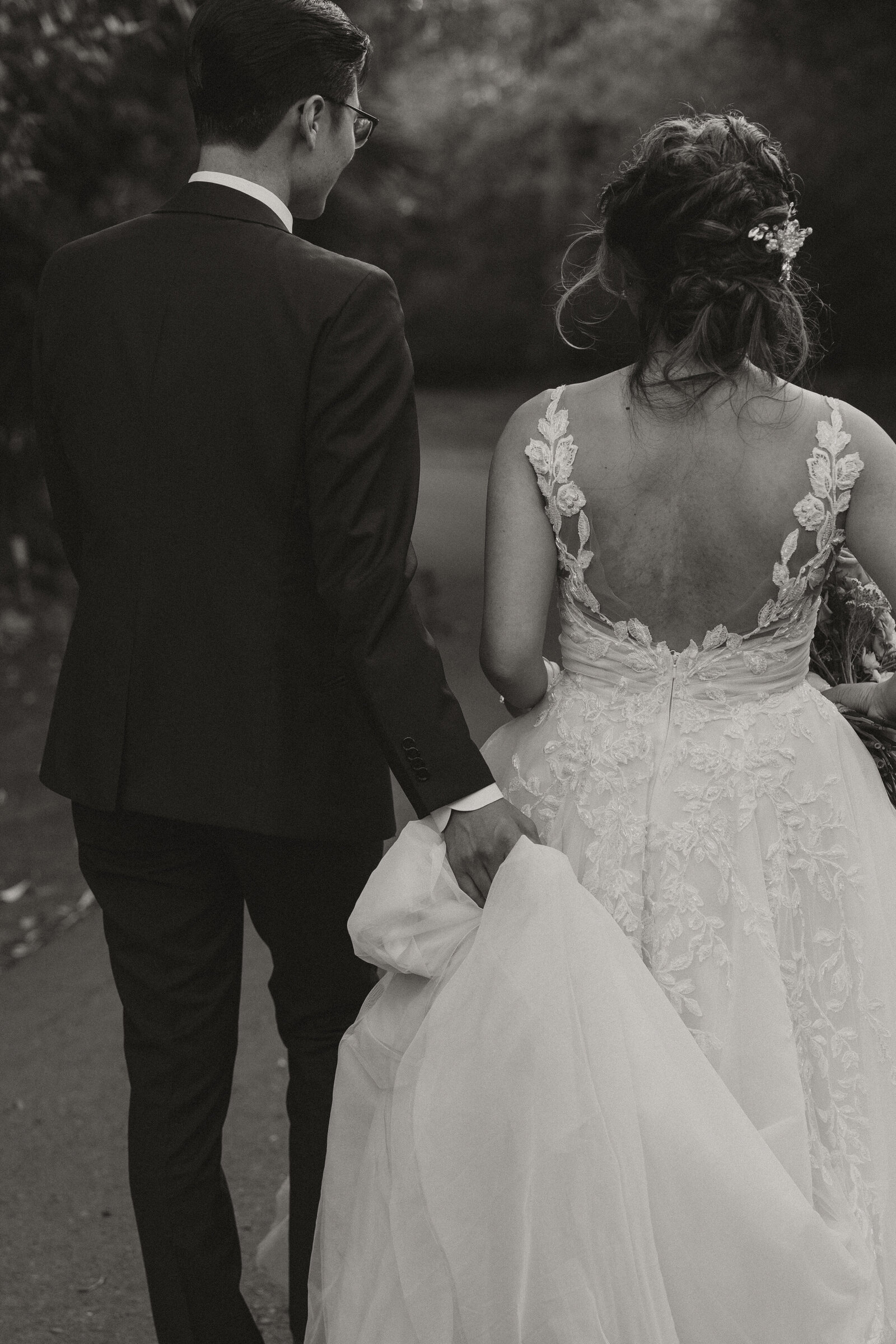 botanica wedding, groom holding wedding dress, bride and groom walking